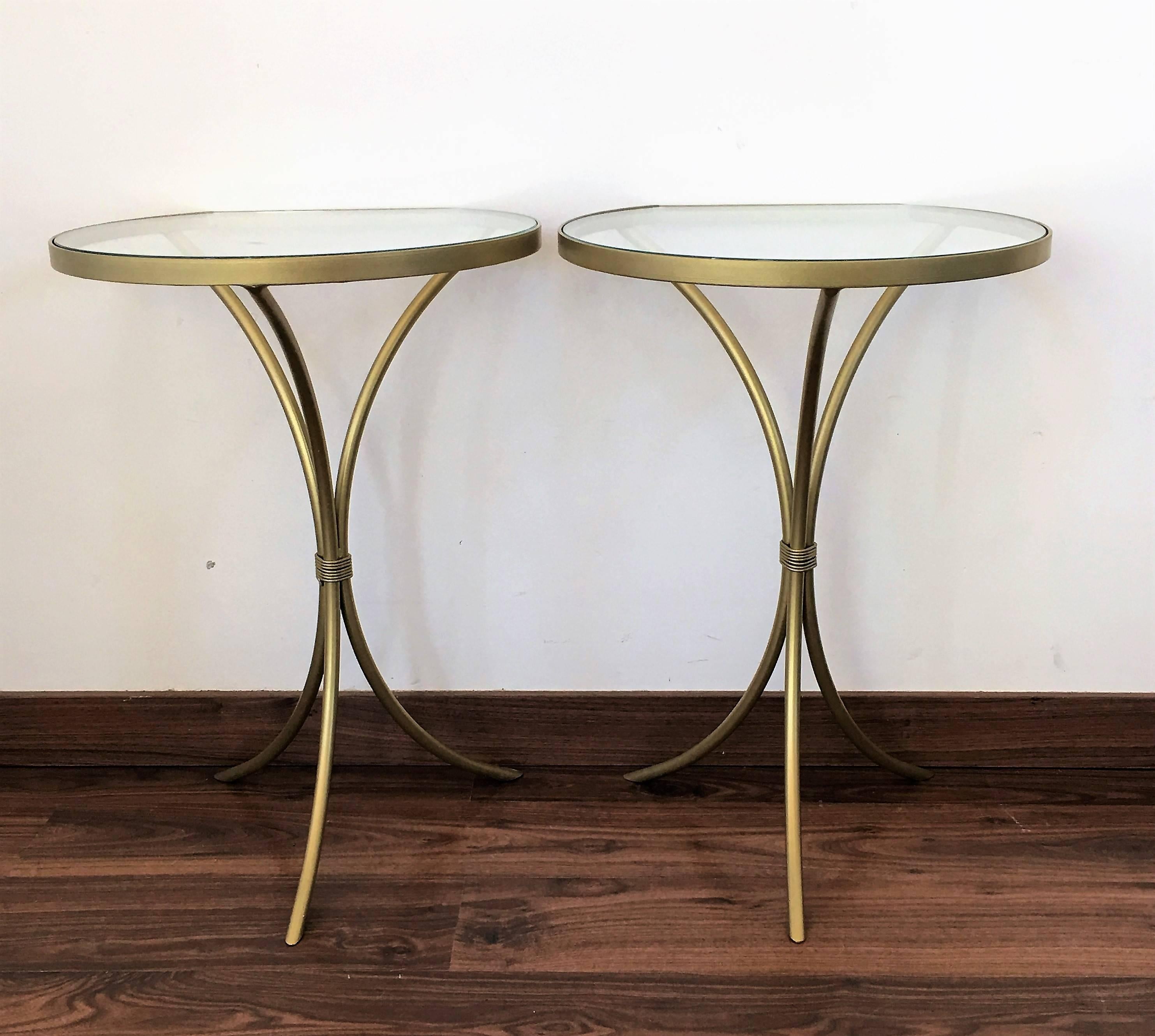 Pair of Italian midcentury glass and brass tripod side, end or nightstands
A pair of Italian midcentury handblown Murano glass side or end tables with round glass tops embedded by large iron finials supported by gold fluted columns resting on gold