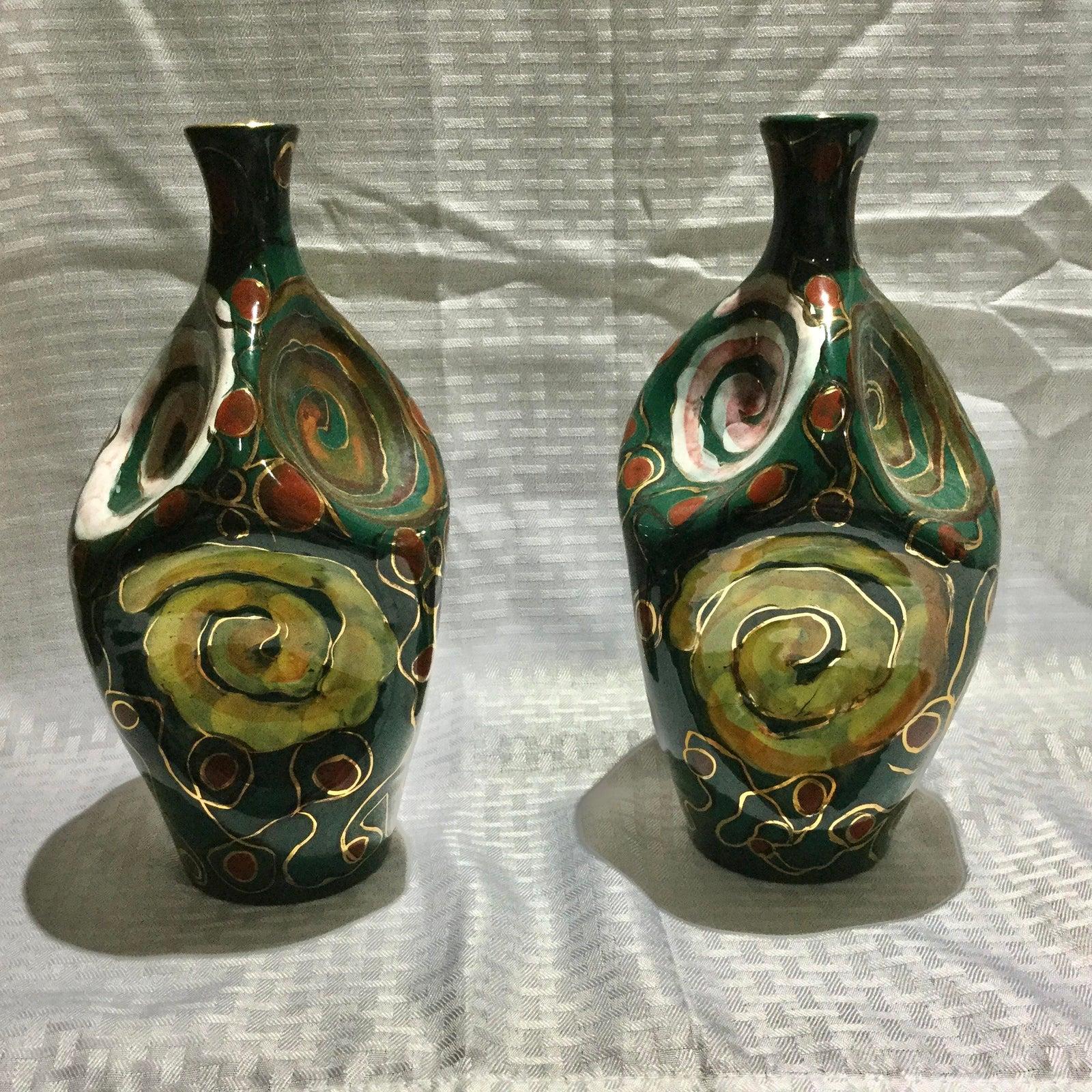 Pair of Italian midcentury glazed terracotta vases. Six indented circles which makes them extremely interesting and each with a different color palette including dark green, rust, light green, light rose, gilt and black. They have good weight to