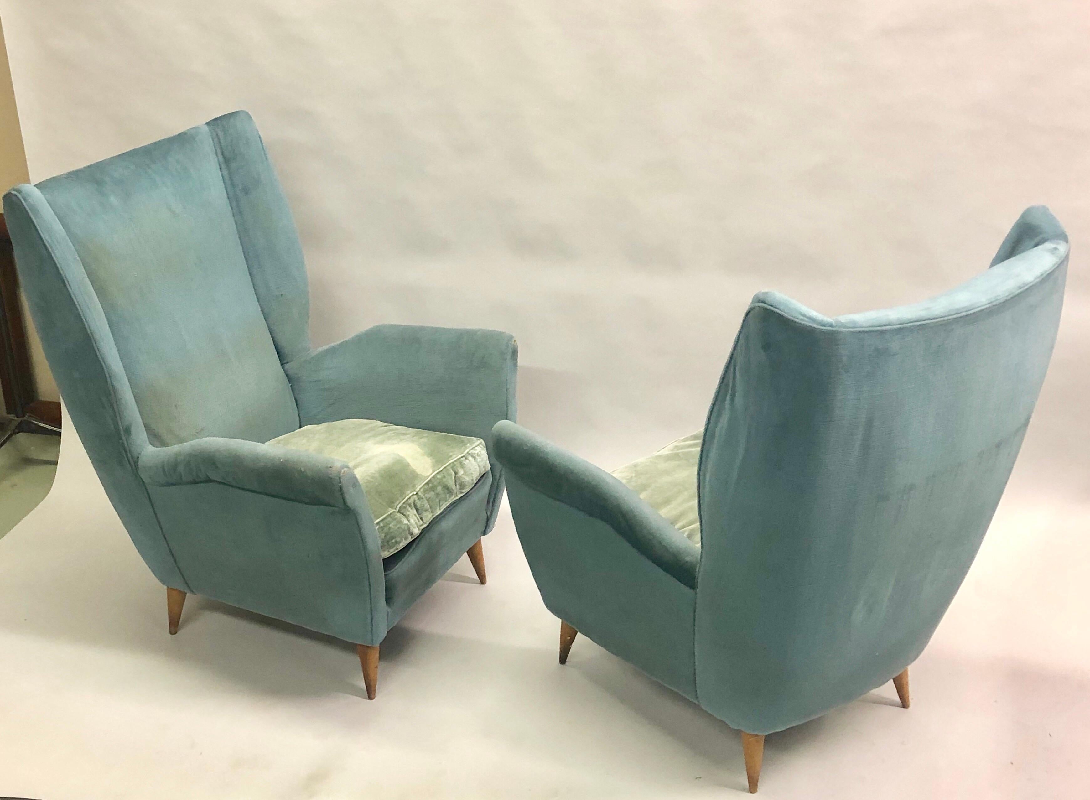An elegant, stunning pair of Italian Mid-Century Modern armchairs or lounge or wingback or high back chairs by Gio Ponti, 1955 for Editions ISA, Bergamo. Gio Ponti was known for working in the Modern Neoclassical style; these chairs reflect that and