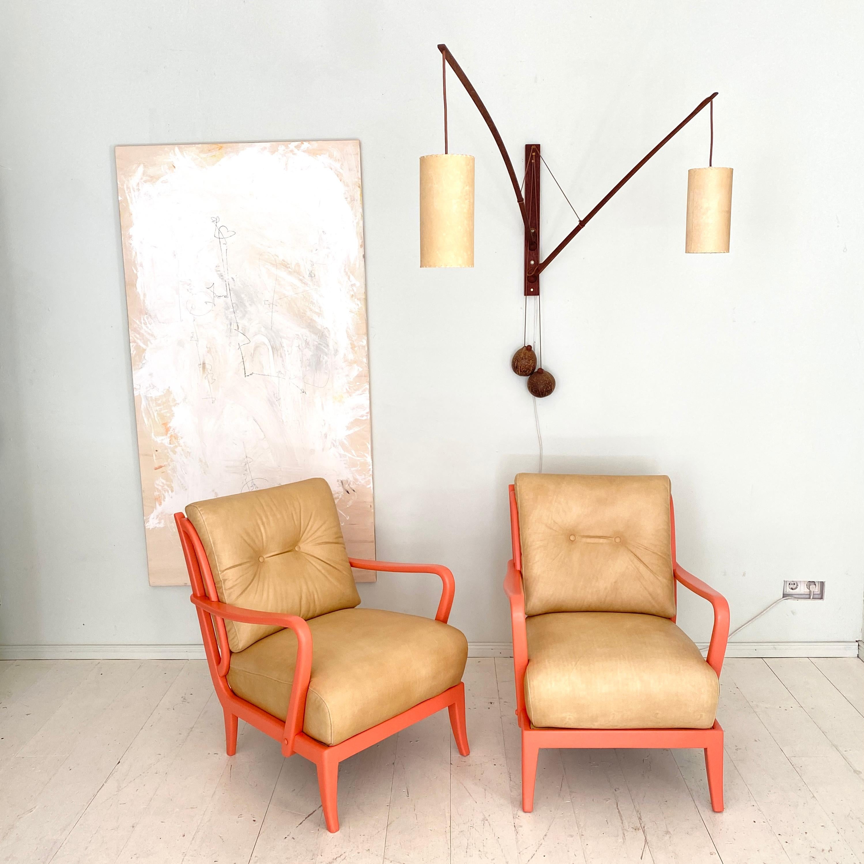 This beautiful pair of Italian mid century lounge chairs where made around 1950.
They are made from solid beech ans lacquered in a coral color and have been reupholstered in a beige vintage leather.
A unique piece which is a great eye-catcher for