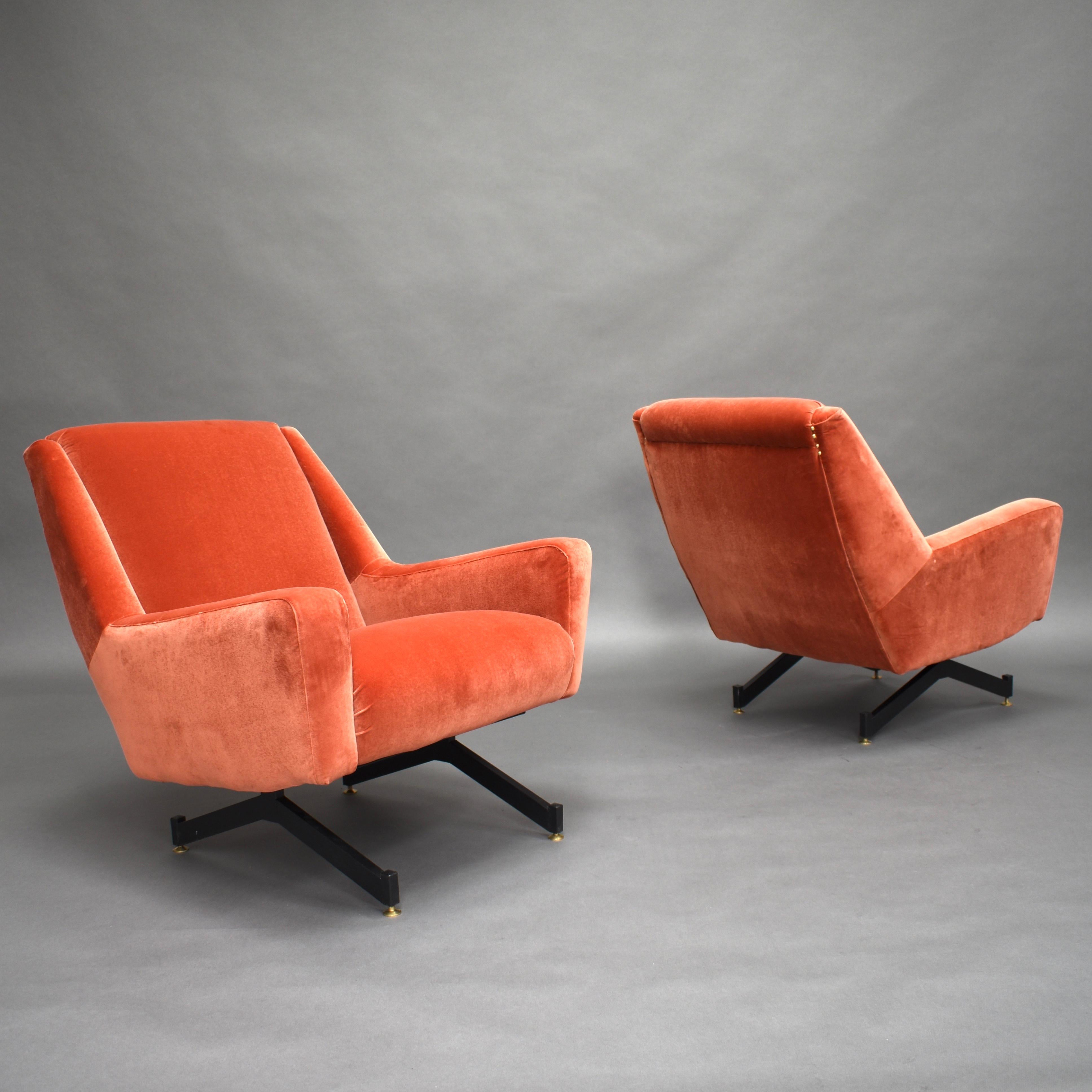 Gorgeous pair of Italian armchairs with new copper pink velvet upholstery.

They feature a black lacquered metal base and four brass feet that can be adjusted in height by turning the feet (for leveling). The metal base gives the chairs a floating