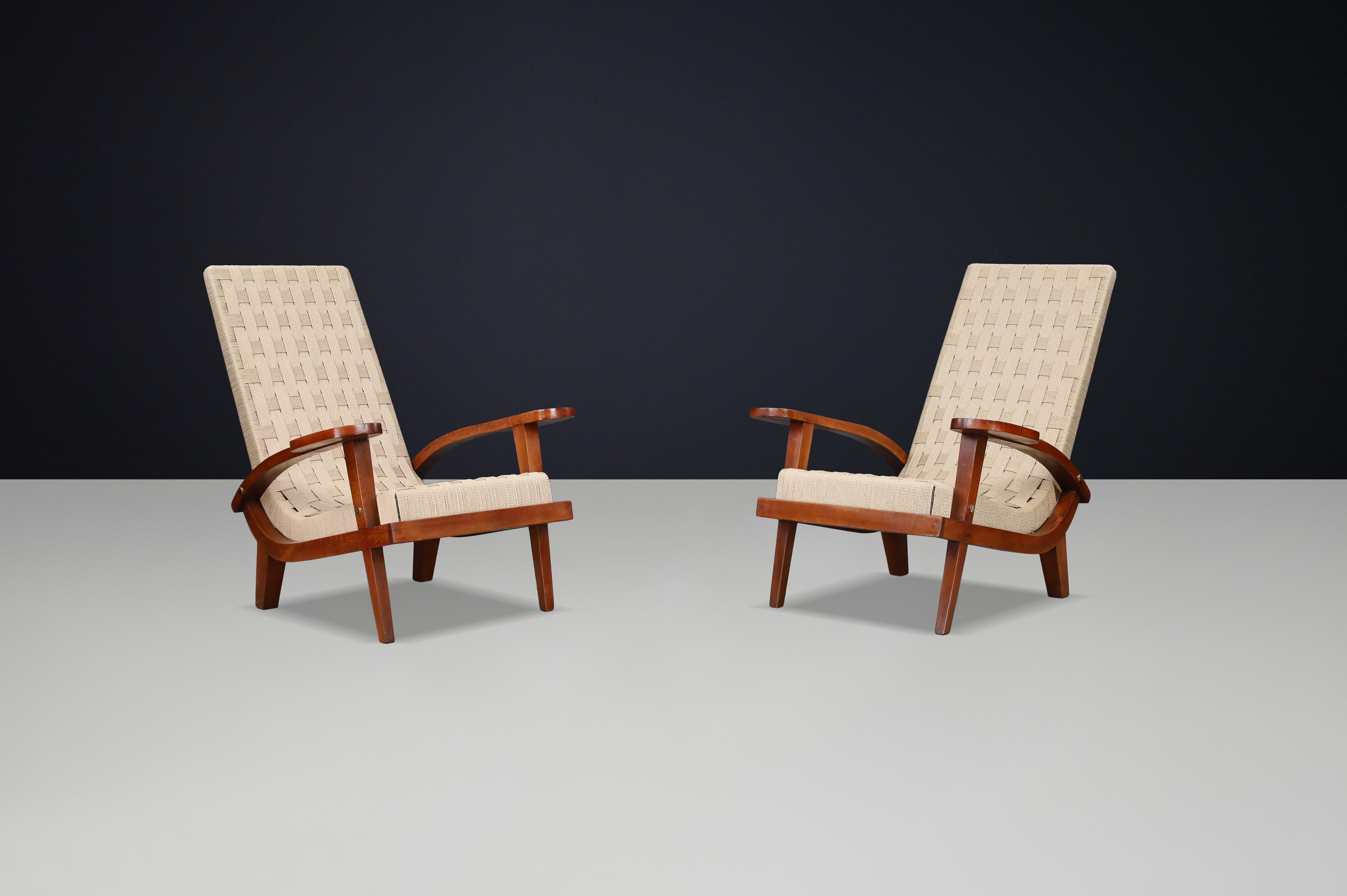 Pair of Italian Mid-Century Lounge Chairs with Webbing, Italy, 1940s

This elegant pair of fully restored lounge chairs captures the essence of Italian craftsmanship from the 1940s — where sculptural woodwork and artisanal precision meet timeless