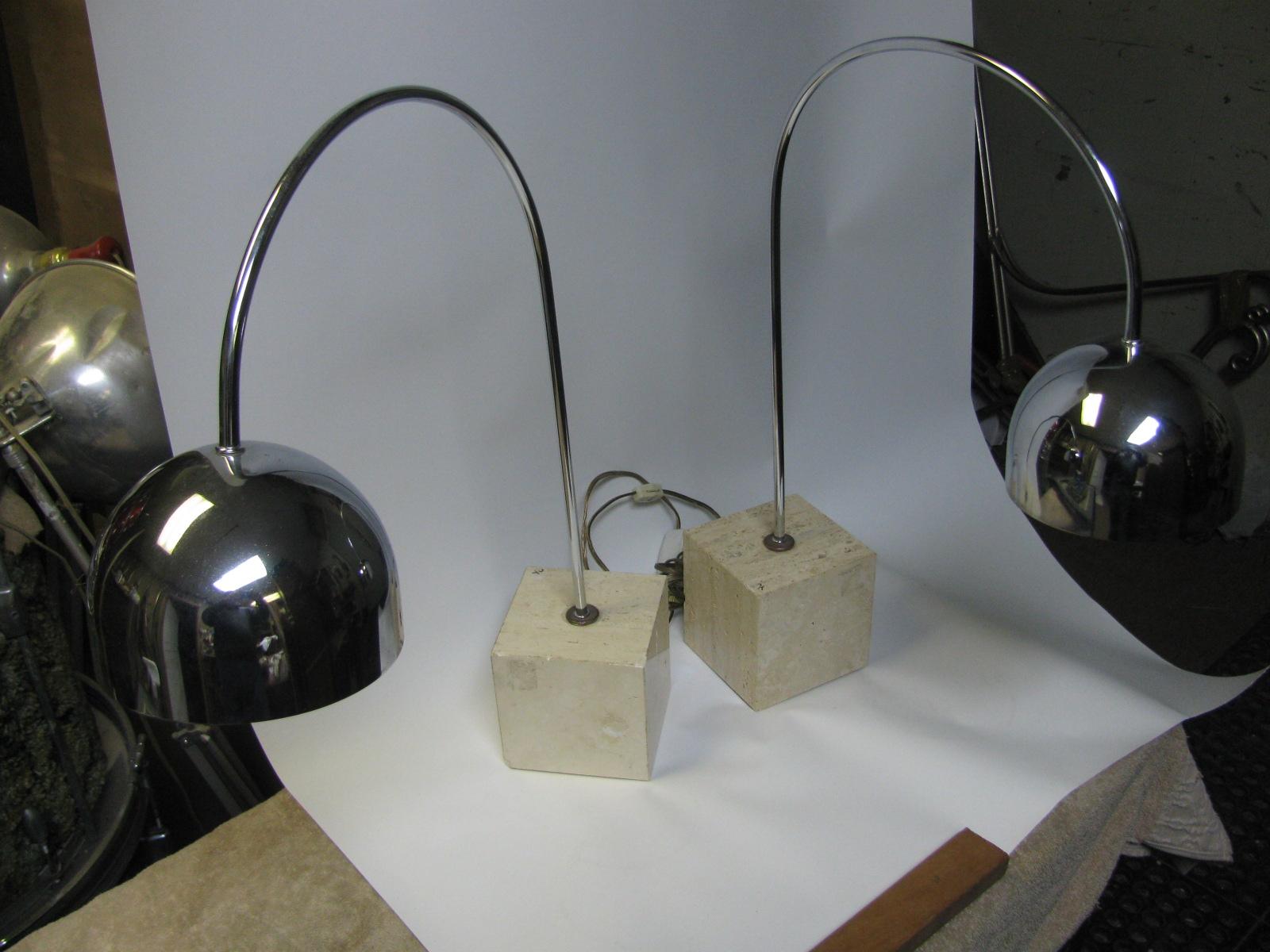 Fabulous pair of chrome arc table lamps with Travertine cube bases. Cube base is 5 x 5 x 5. Harvey Guzzini design.