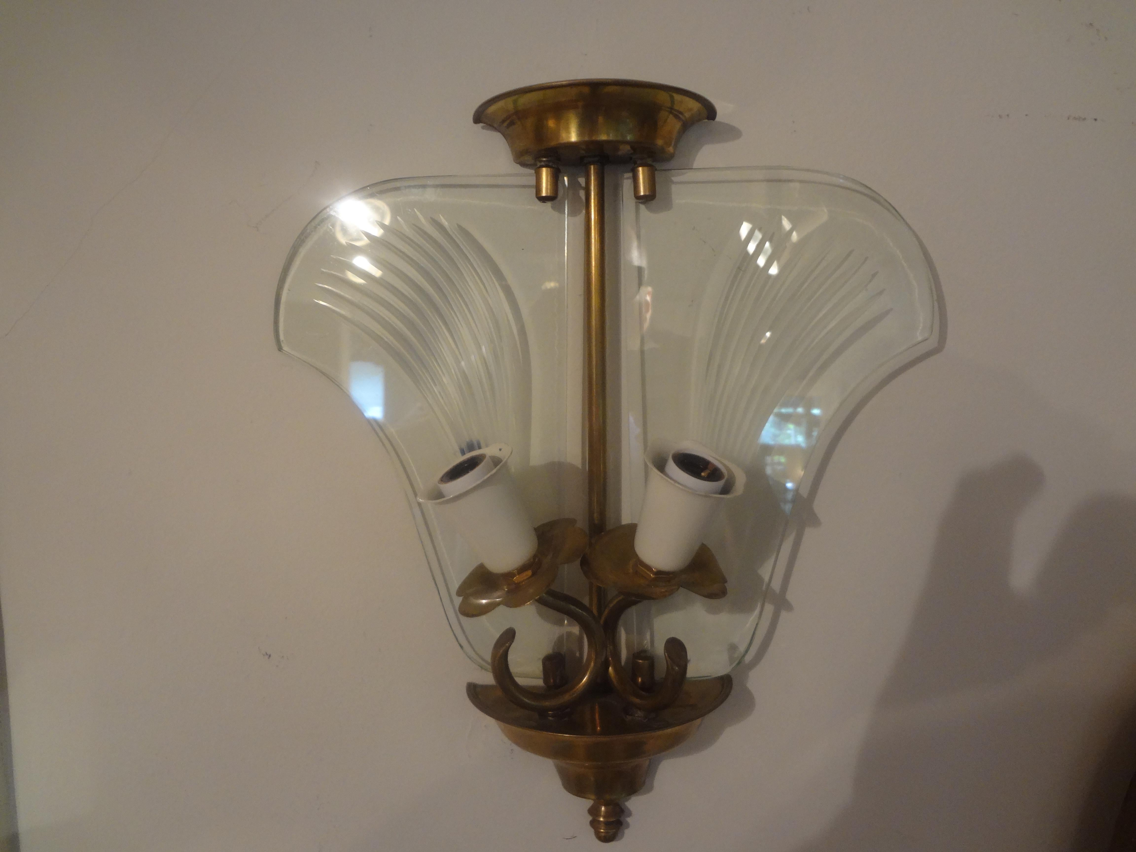 Pair of Italian Fontana Arte style brass and etched glass sconces.
Pair of Italian Mid-Century Modern brass and etched glass sconces. This interesting pair of Italian Gio Ponti / Fontana Arte inspired sconces have been newly wired with great patina.