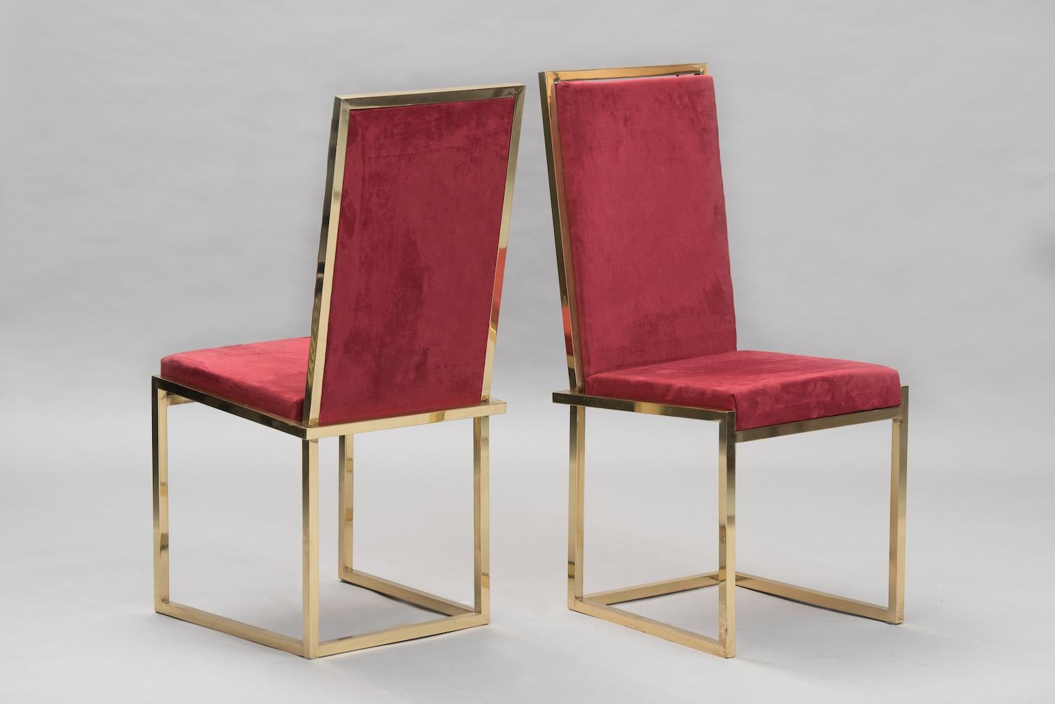 A pair of high back chairs in brass and bordeaux suede.