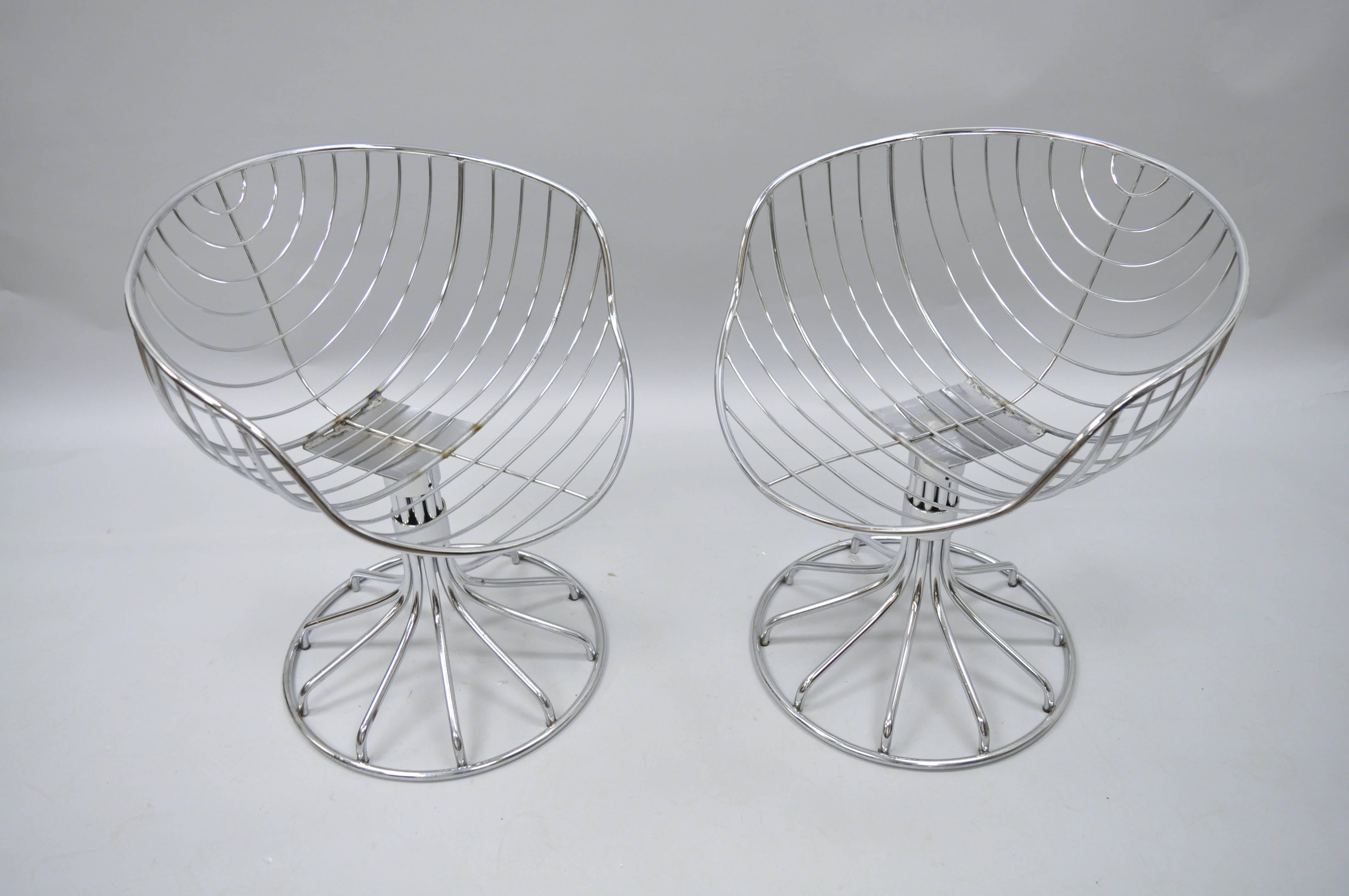 Pair of vintage Italian Mid-Century Modern chrome wire frame swivel chairs attributed to Gastone Rinaldi for Rima. Chairs feature swivel pedestal bases, sleek sculptural form, and original brown suede cushions (which show wear). Measurements 28