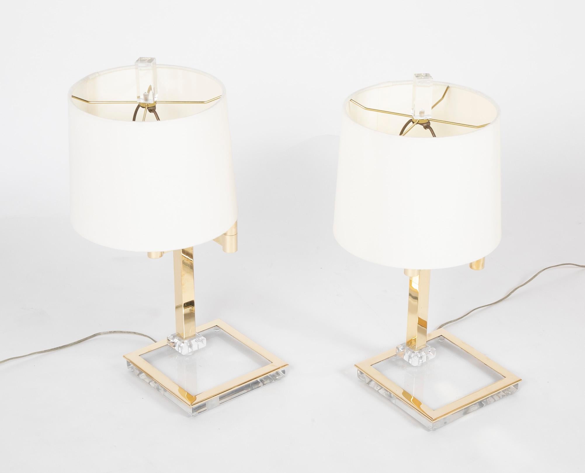 Both stylish and practical, this is a great looking pair of Italian Mid-Century Modern brass and lucite table lamps. The adjustable swing arms make these perfect for a desk or pair of end tables or bedside tables. With original lucite finials. 
I
