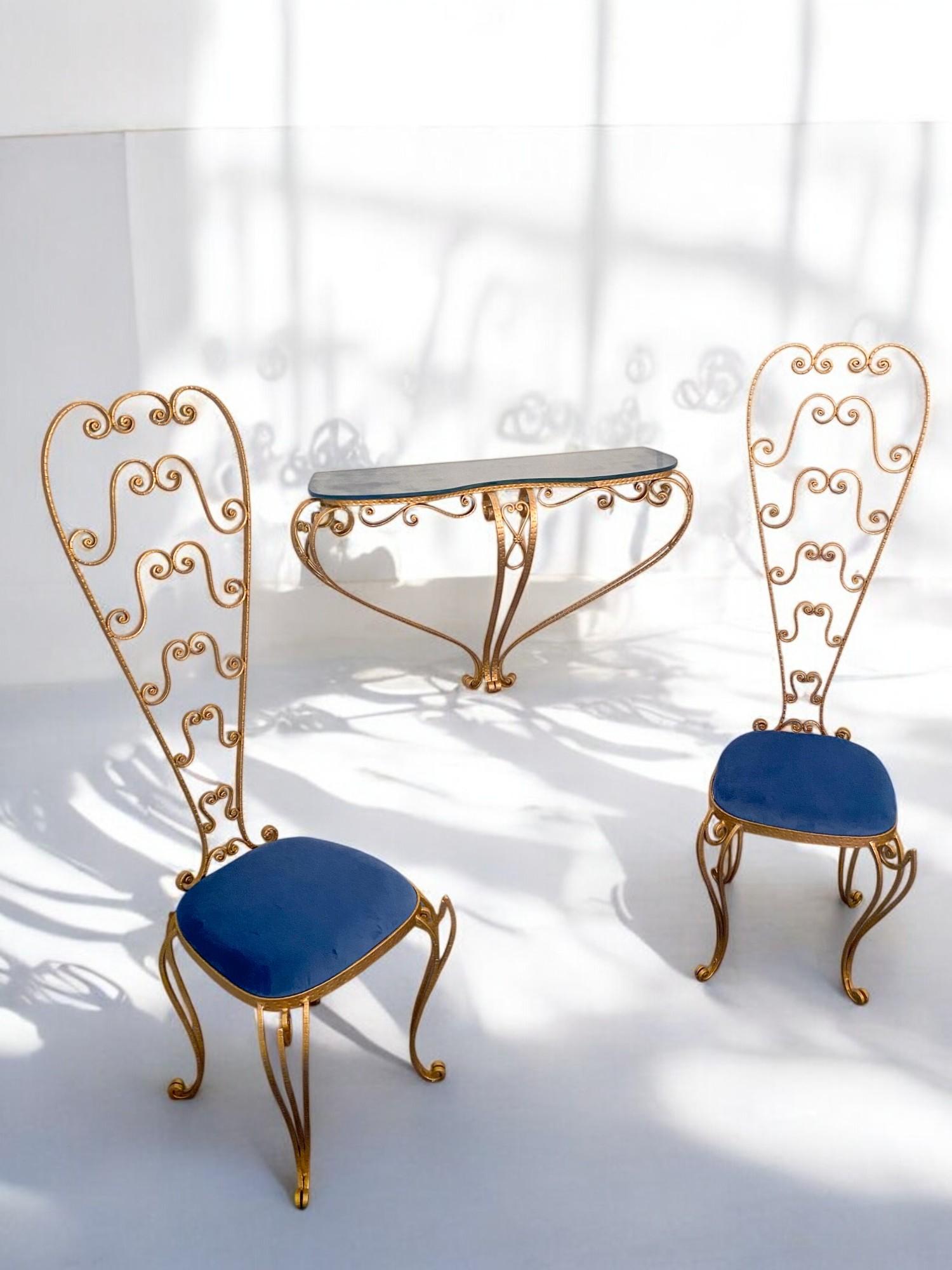 Apair of stunning Italian Mid-Century Modern chairs, look no further than these Luigi Colli vanity chairs. Made from gold gilded iron and featuring a high backrest, these chairs are as beautiful as they are functional. The deep blue microfiber