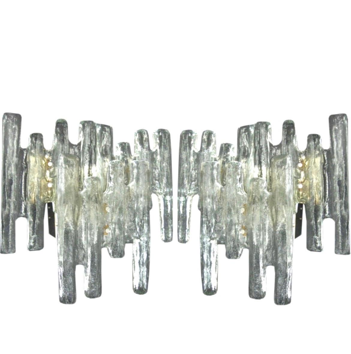 A Stunning Pair of Italian Mid-Century Modern Hand Blown Venetian glass wall lights / Sconces in the form of Icicles and in a clear, opaque color by AV Mazzega, Italy, circa 1970. The pieces combine a rare, naturalistic form with the neutrality of