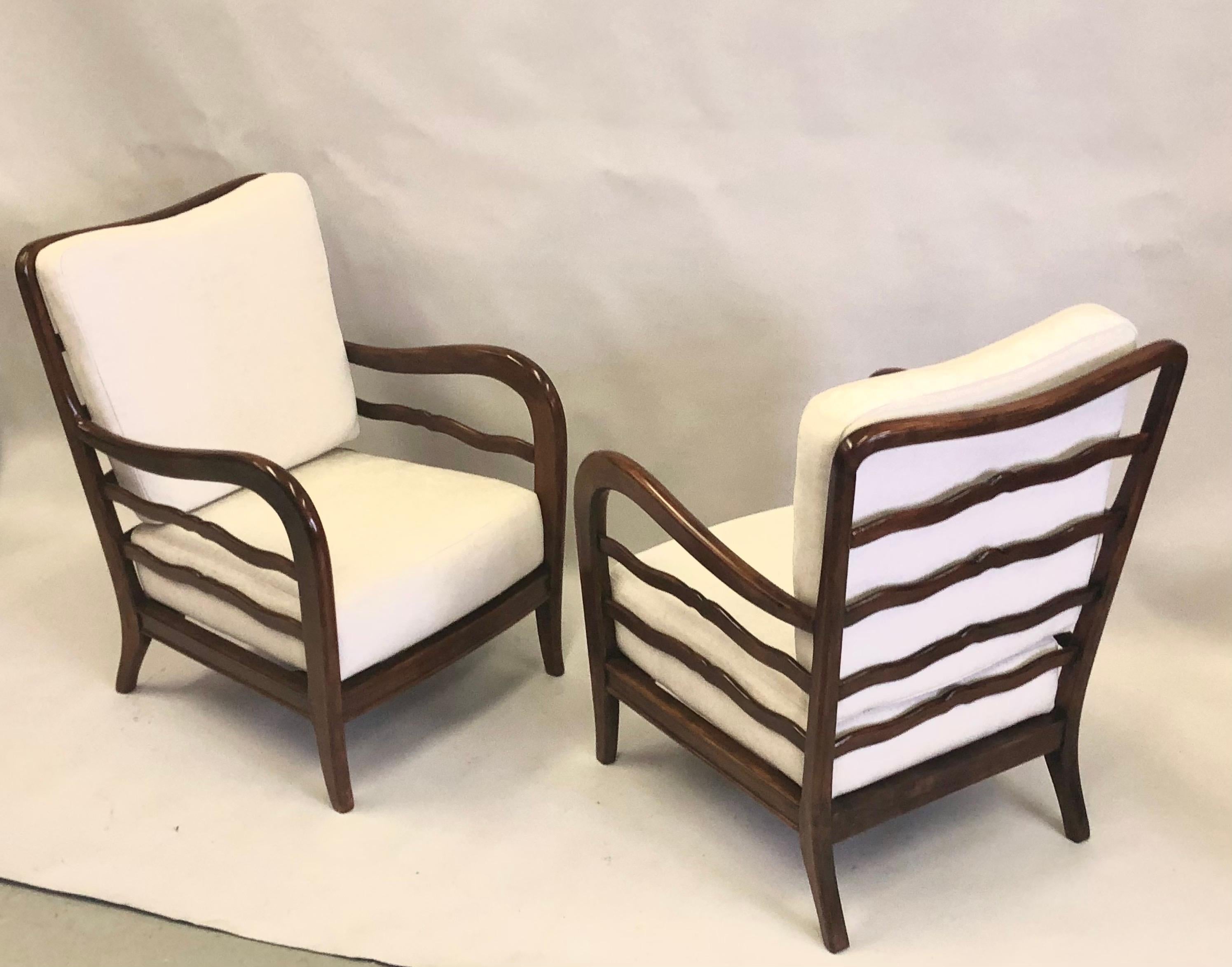 A rare and elegant pair of Italian Mid-Century Modern Neoclassical lounge chairs or Armchairs attributed to Poalo Buffa circa 1946. The chairs feature unique, refined styling and luxury. They demonstrate their modern neoclassical aesthetics with