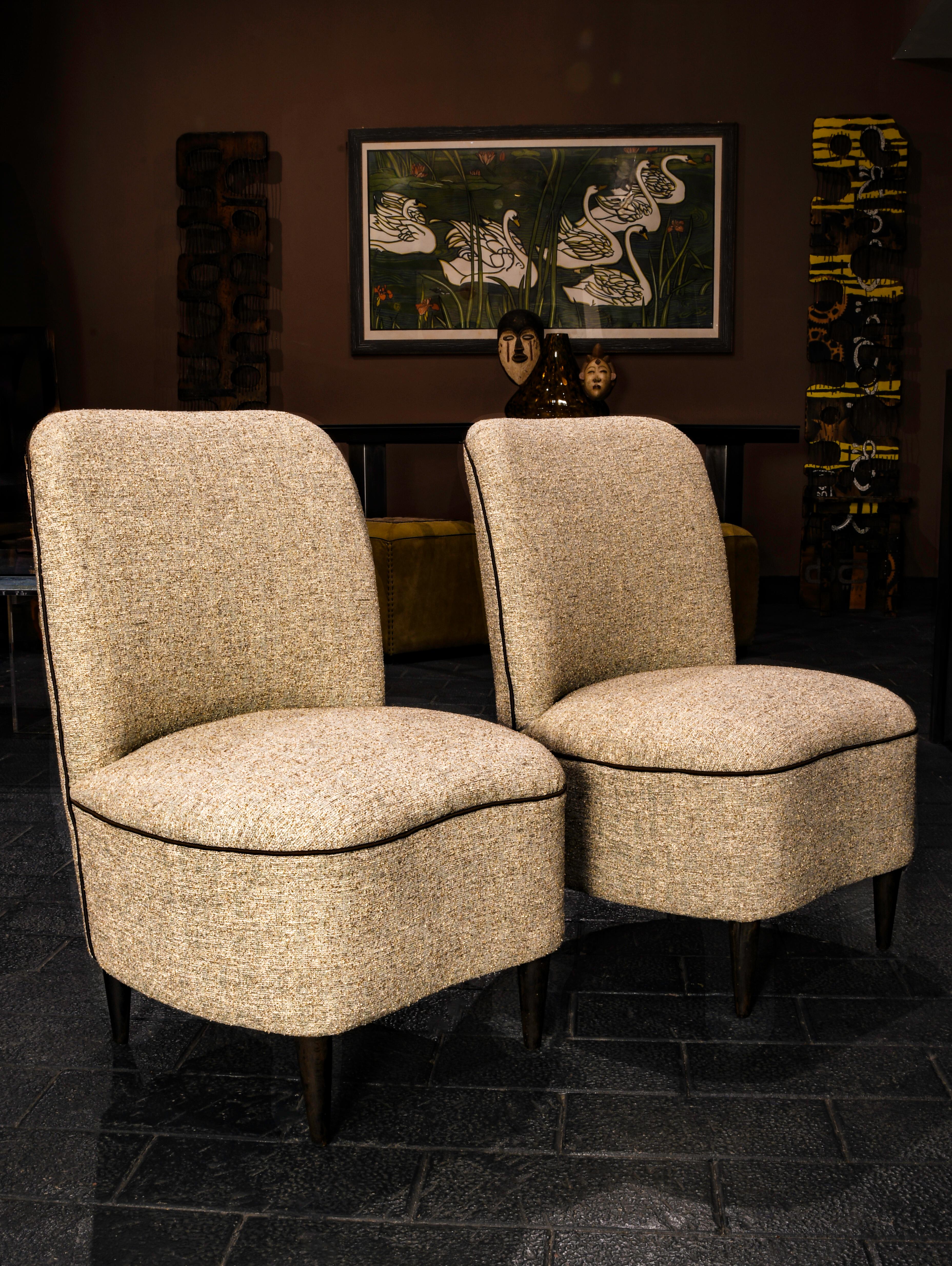 A minimal and elegant pair of Italian vintage mid century modern, bedroom slipper chairs; Beautifully proportioned with a comfortable and seats and backrests, the chairs is supported on tapered  wooden legs. The chairs are constructed in a solid