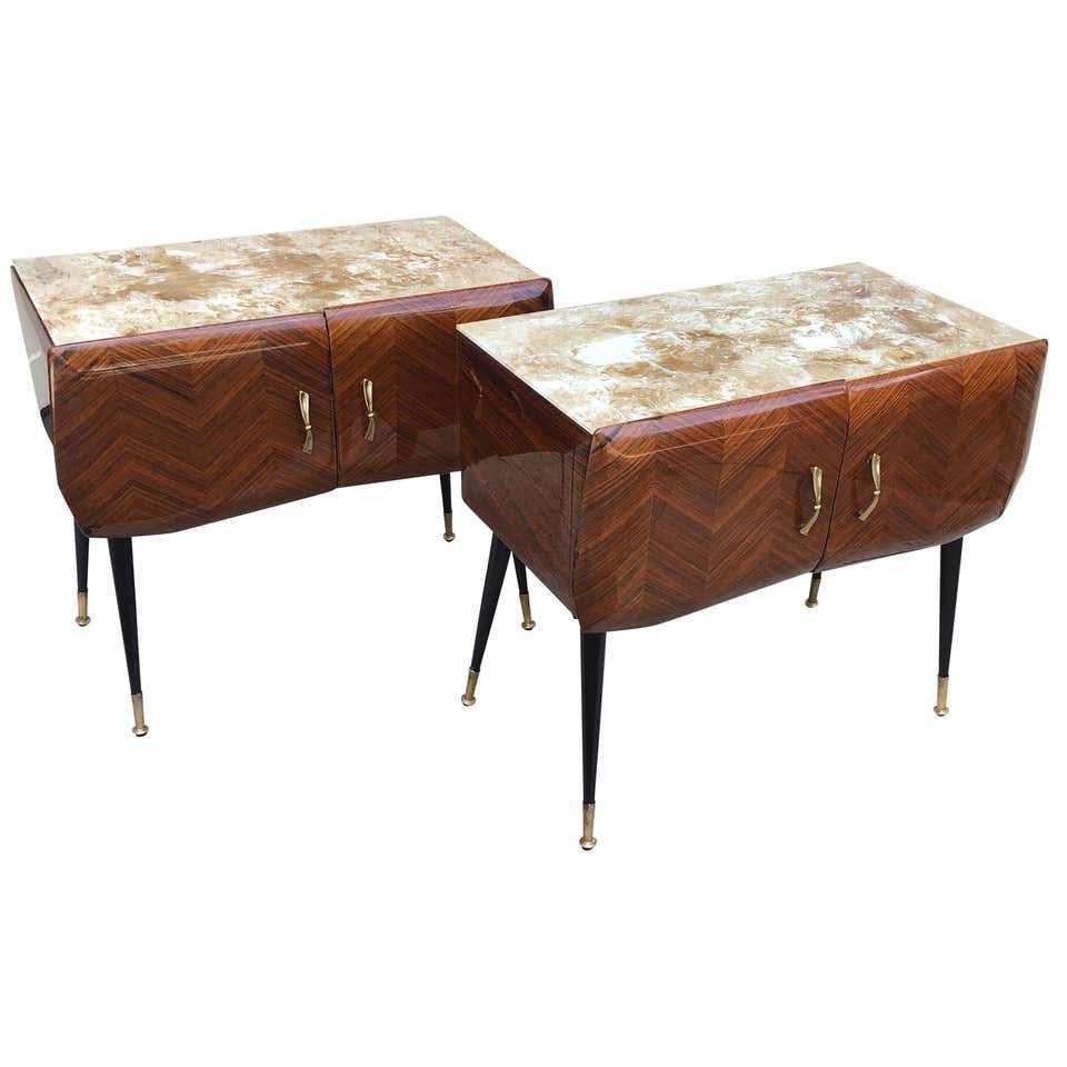Pair of Italian midcentury bedside tables with two doors by Vittorio Dassi of Milano. Tables have the original glass top and brass feet.