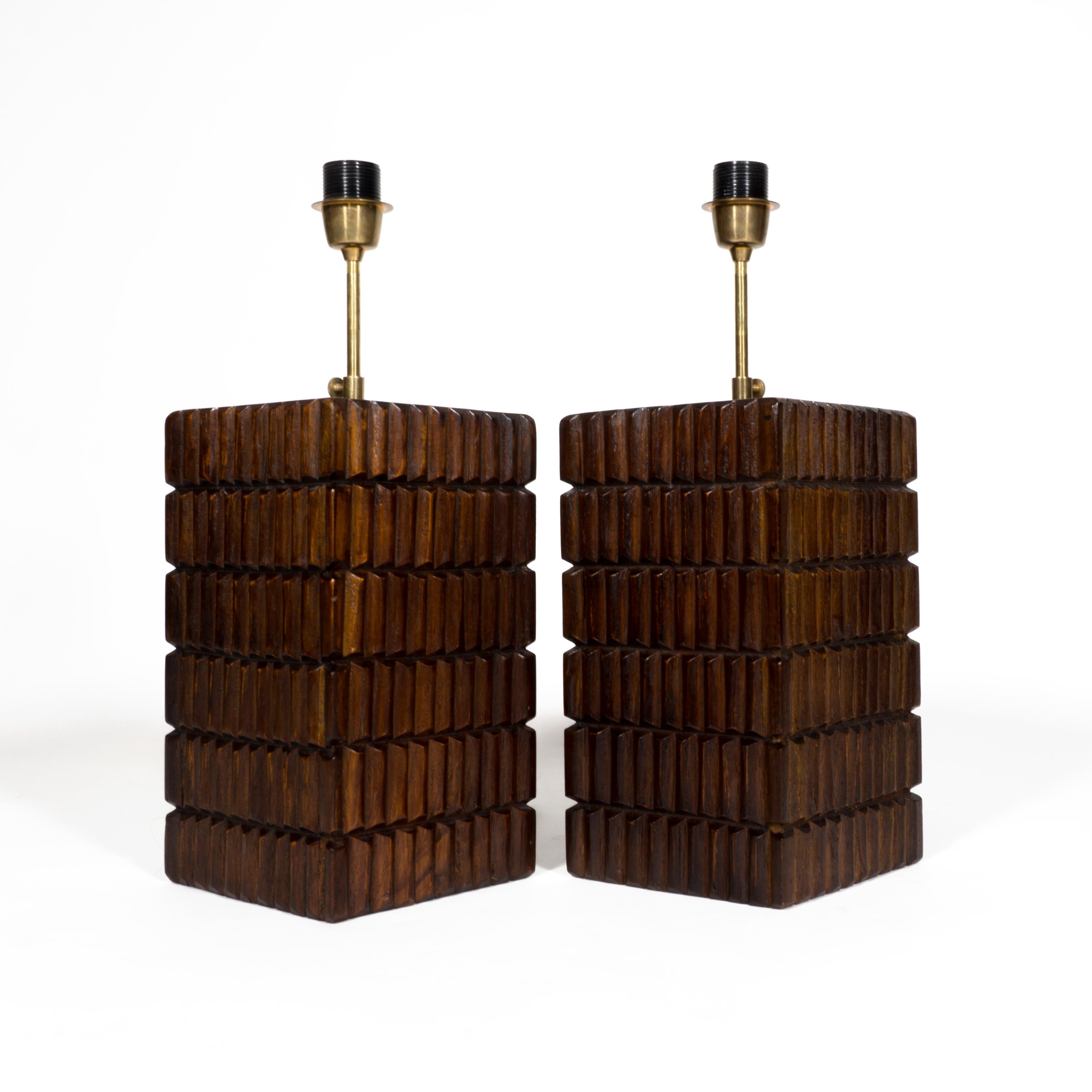Stunning pair of mid-century modern wooden table lamps made in Italy. 
The sculptural and abstract wooden base of the lamp is accompanied by a brass rod. The height of the rod can be individually adjusted - depending on your wishes and future