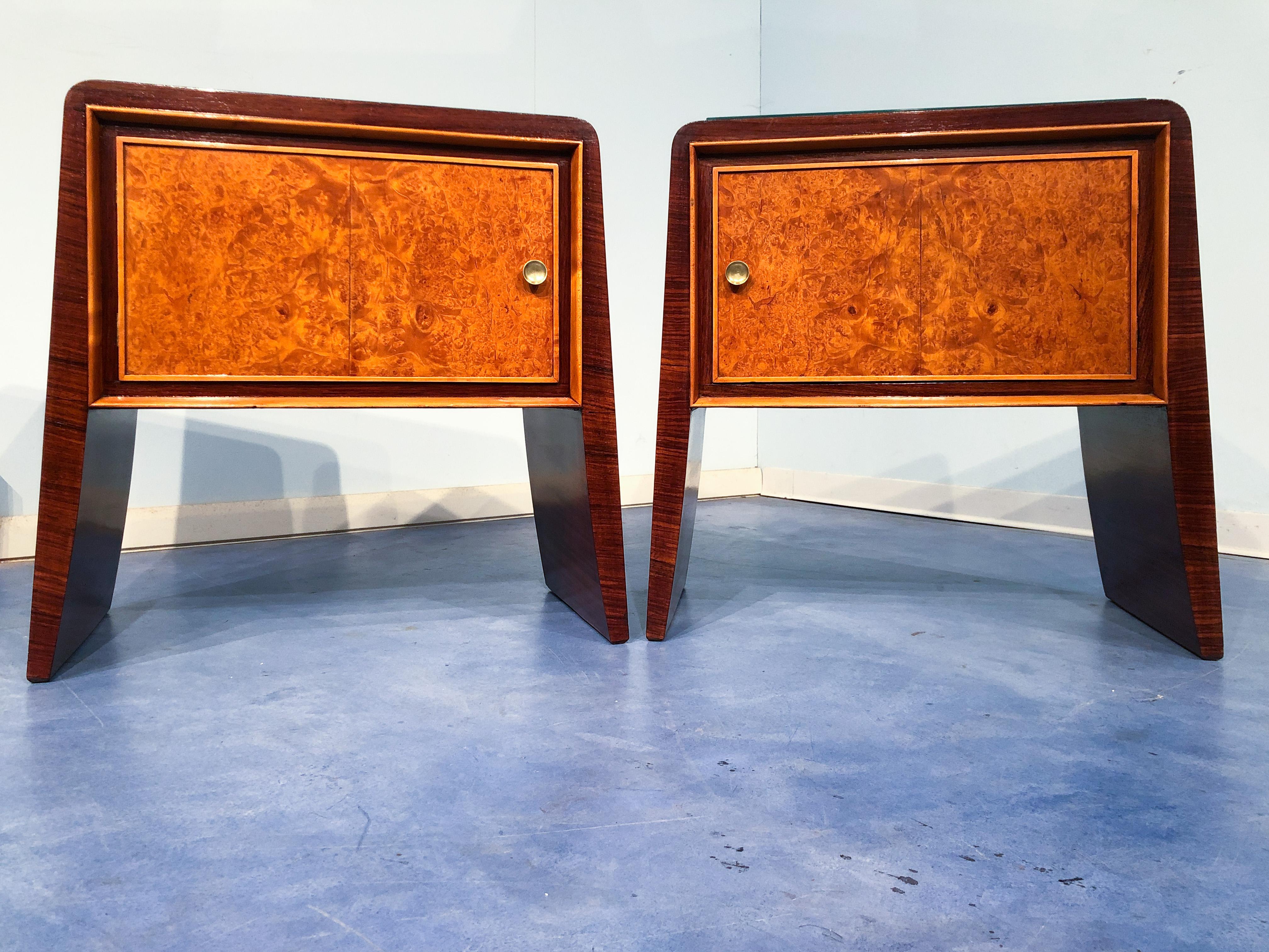 Pair of stunning Italian nightstands or bedsides tables attributed to Guglielmo Ulrich, produced in the 1950s. The top and sides are made of precious rosewood on solid tapering flared legs enclosing a birdseye maple door with circular brass pull.