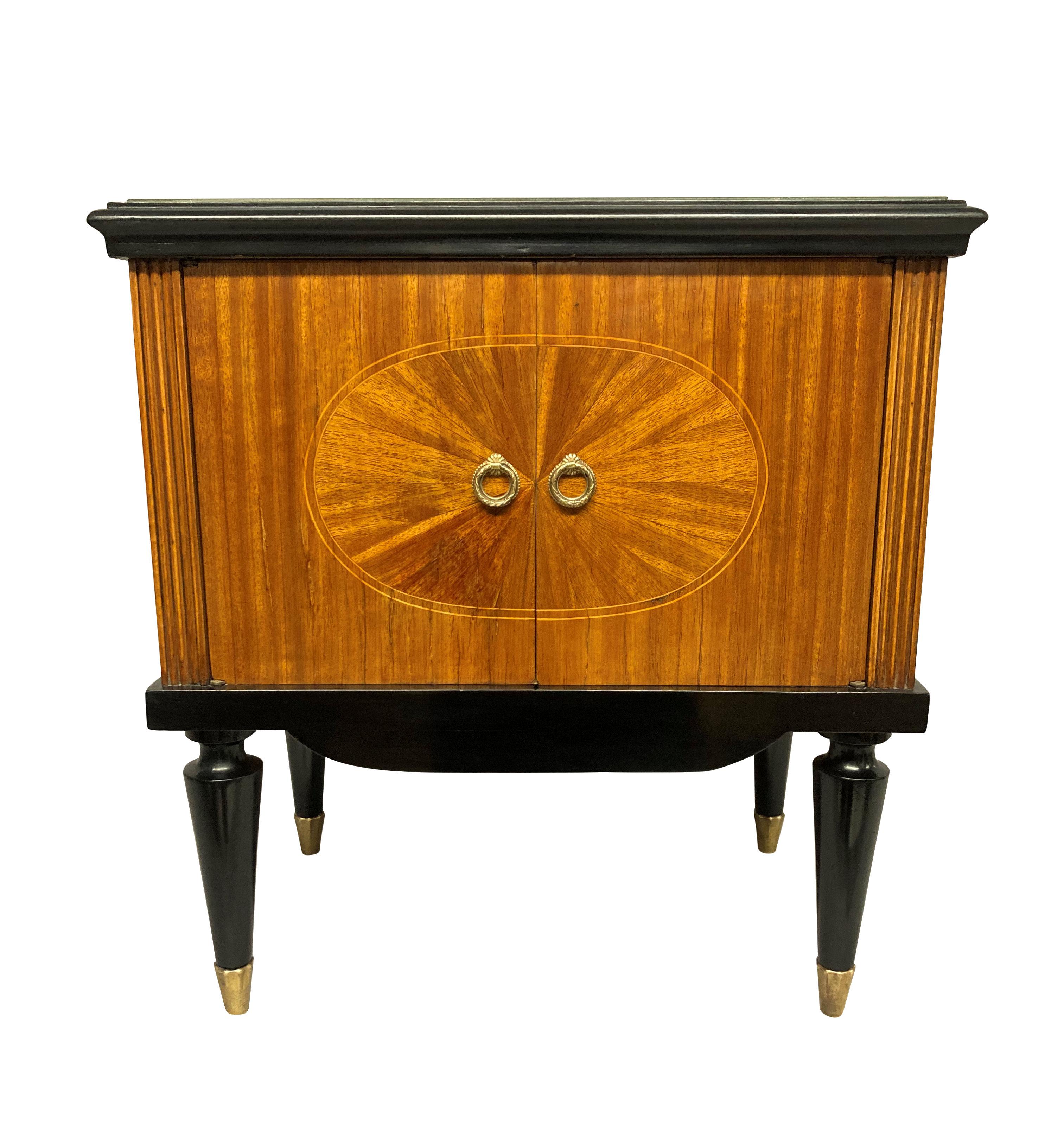 A pair of fine Italian mid-century night stands, finely veneered with ebonised detailing, brass sabot and champagne coloured glass tops.