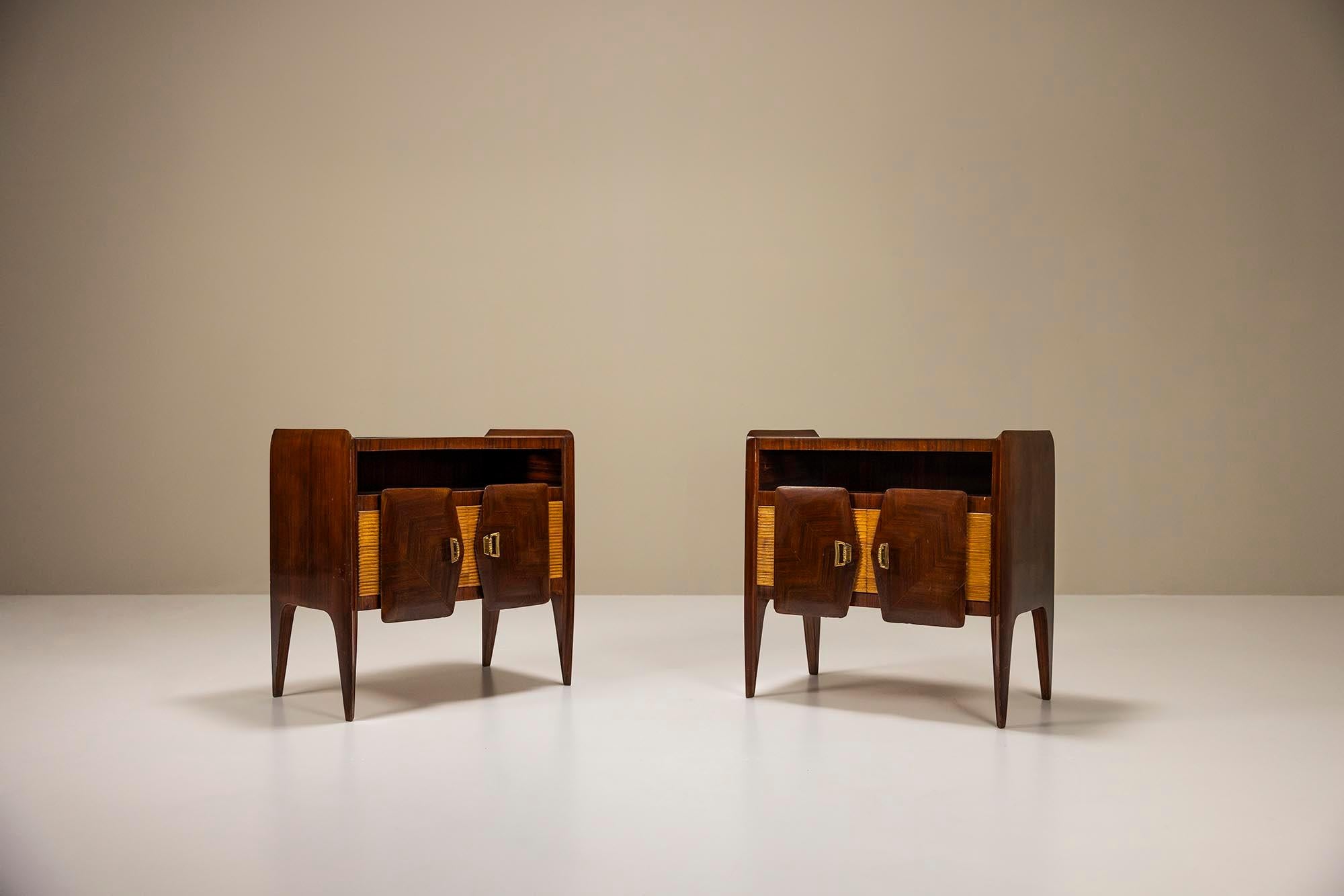 Nightstands veneered in rosewood and glass top in the manner of Borsani.These 1950s Italian bedside tables do not lack style or refinement. Sharp raised edges and a ribbed facade with overlapping door panels make one think in the direction of