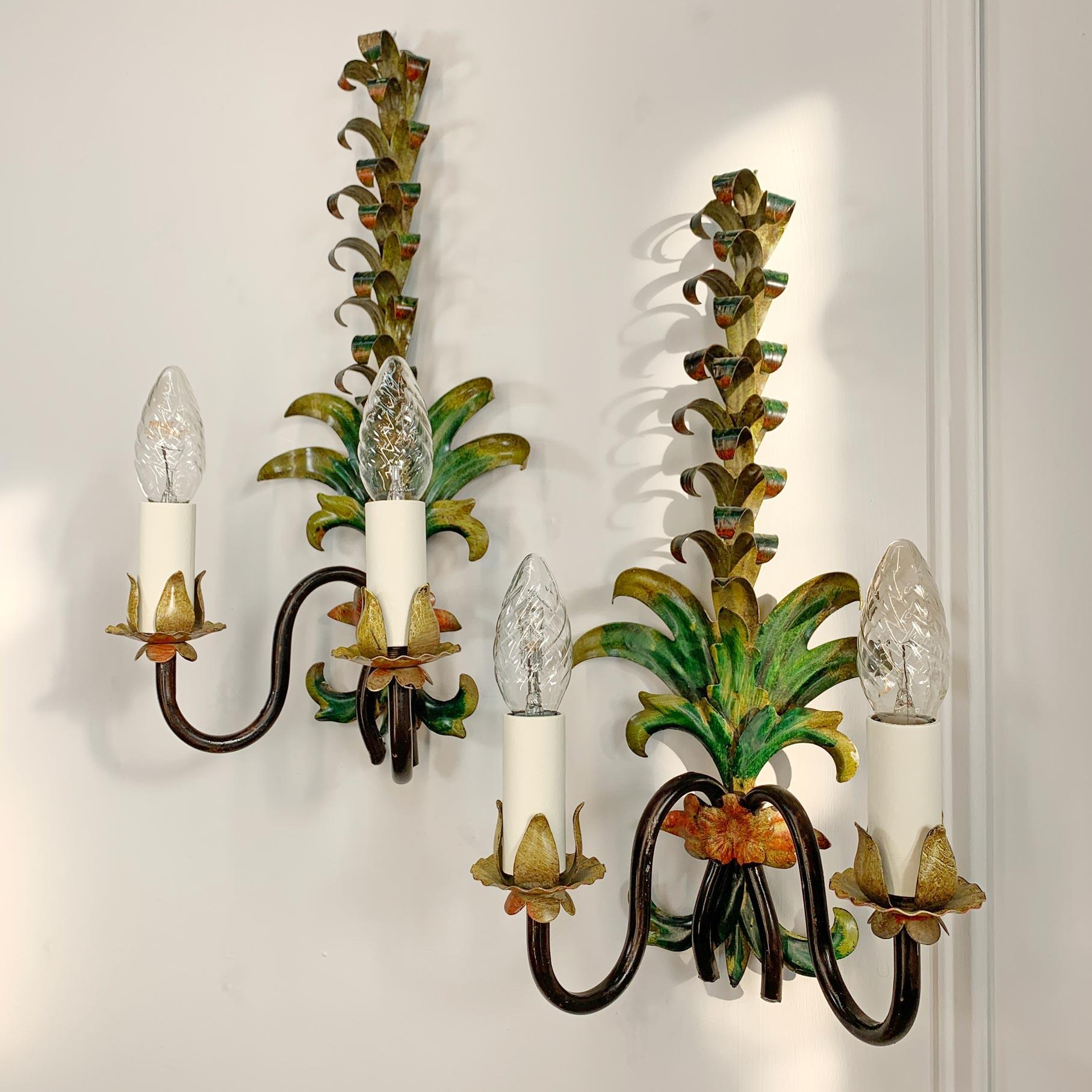 A hand panted pair of Italian wall lights, modeled as tall palm fronds, dating to the 1950's.

Each light has two e14 (small screw in bulb) lamp holders.

Height 41cm, Width 21cm, Depth 14.5cm

Fully rewired and PAT tested.

Price is for the pair of