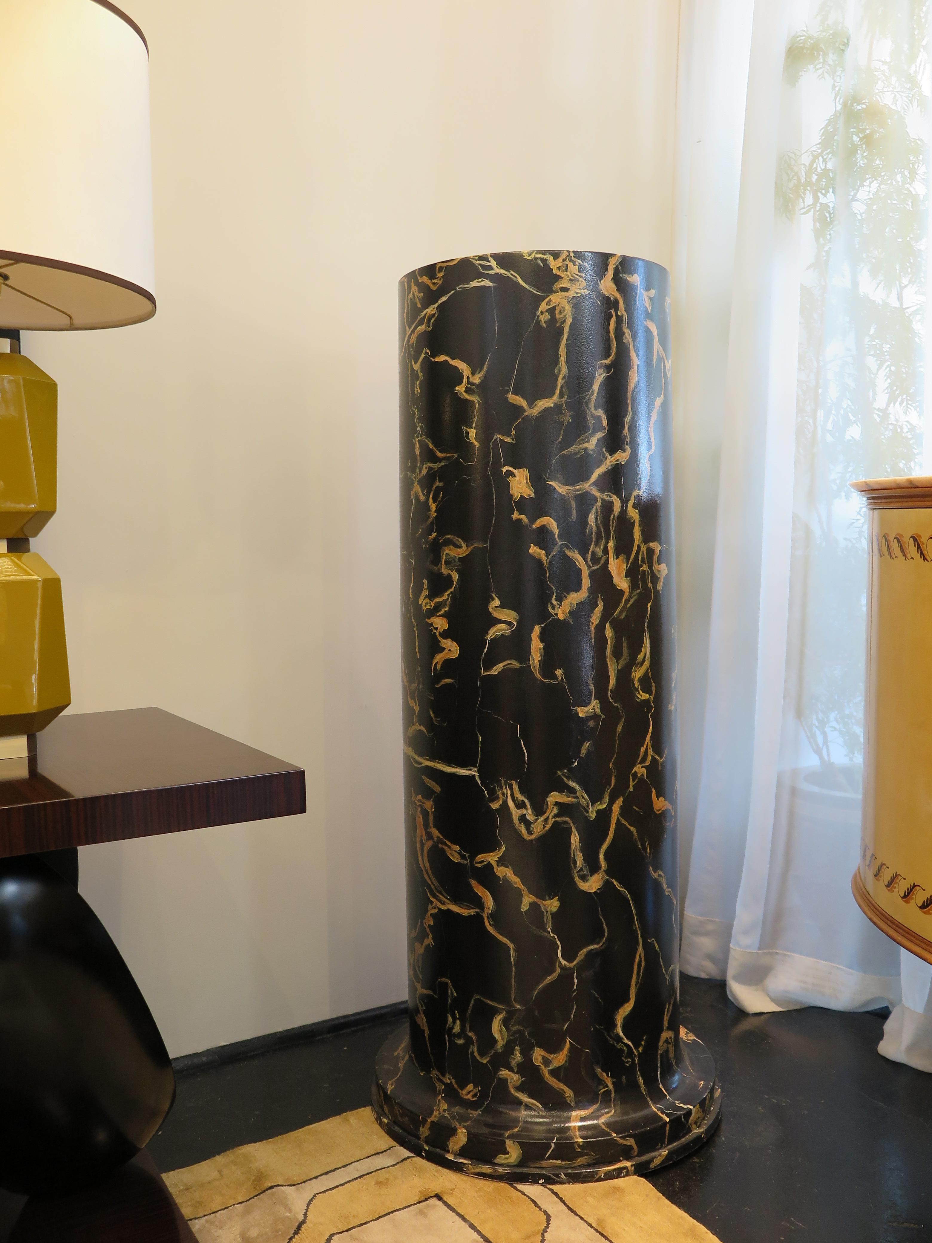 Pair of Pedestals with a hand-painted marble finish in black and gold. Rounded Stepped base. These pieces are in their original condition.