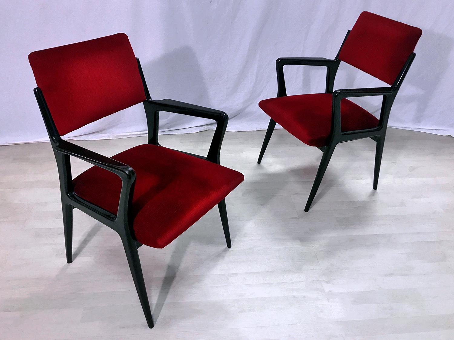 Very stylish Italian midcentury pair of Armchairs original of the 1950s, upholstered in a gorgeous deep scarlet red velvet.
The armchairs are ready to use.
Their structures, made of ebonized wood polished, are solid and in very good conditions of