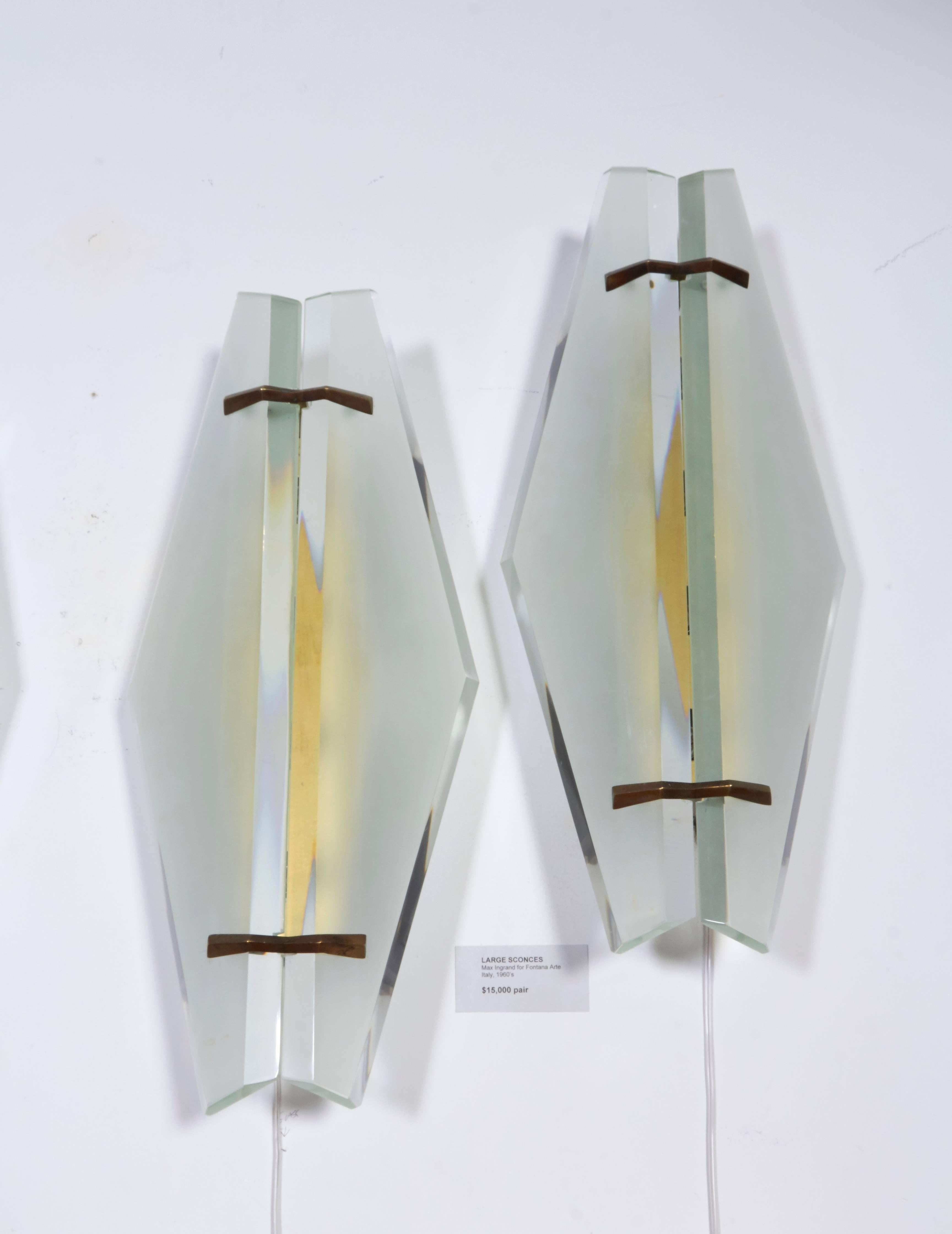 Wonderful pair of bevel cut and frosted glass sconces that have been rewired with American candelabra sockets.