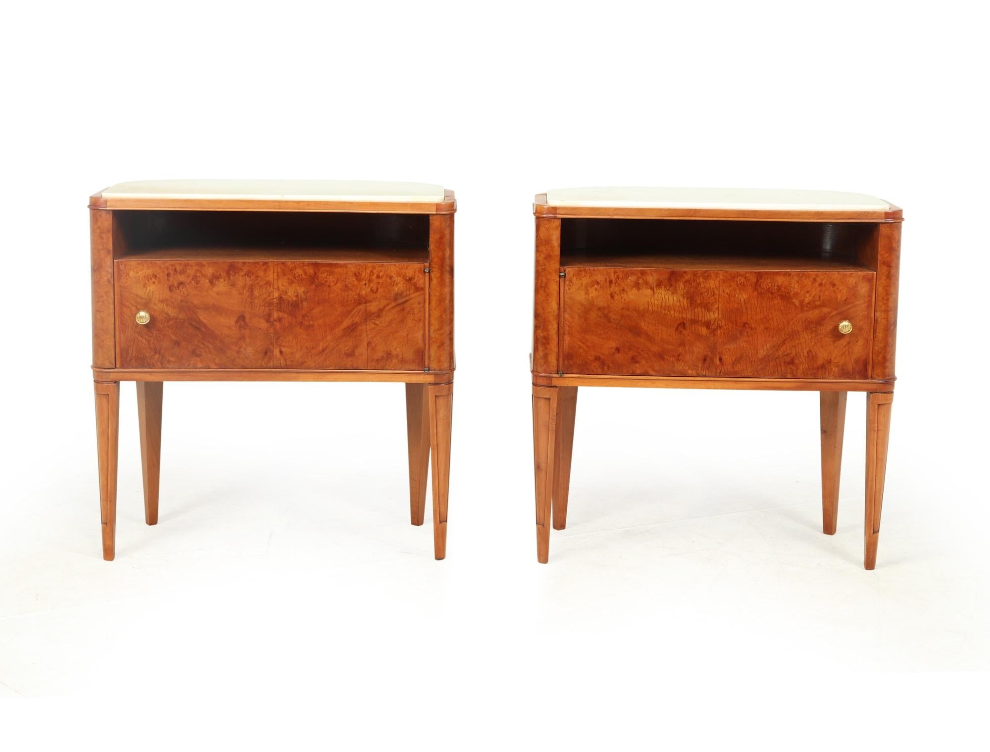 A pair of 1950’s burr walnut Italian side cabinets with white Granite tops can be used as bedside tables but as they are curved and polished all round they can be free standing in the center of a room either side of a sofa. The cabinets have been