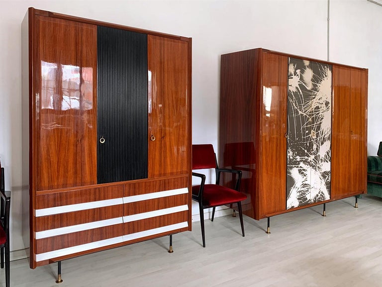 Stunning pair of Italian Armoires, 3 and 5-door, well designed by Vittorio Dassi in the 1950s.

Both structures are made of a gorgeous lacquered teakwood, supported by black metal legs finished with adjustable brass feet.

All interiors are made