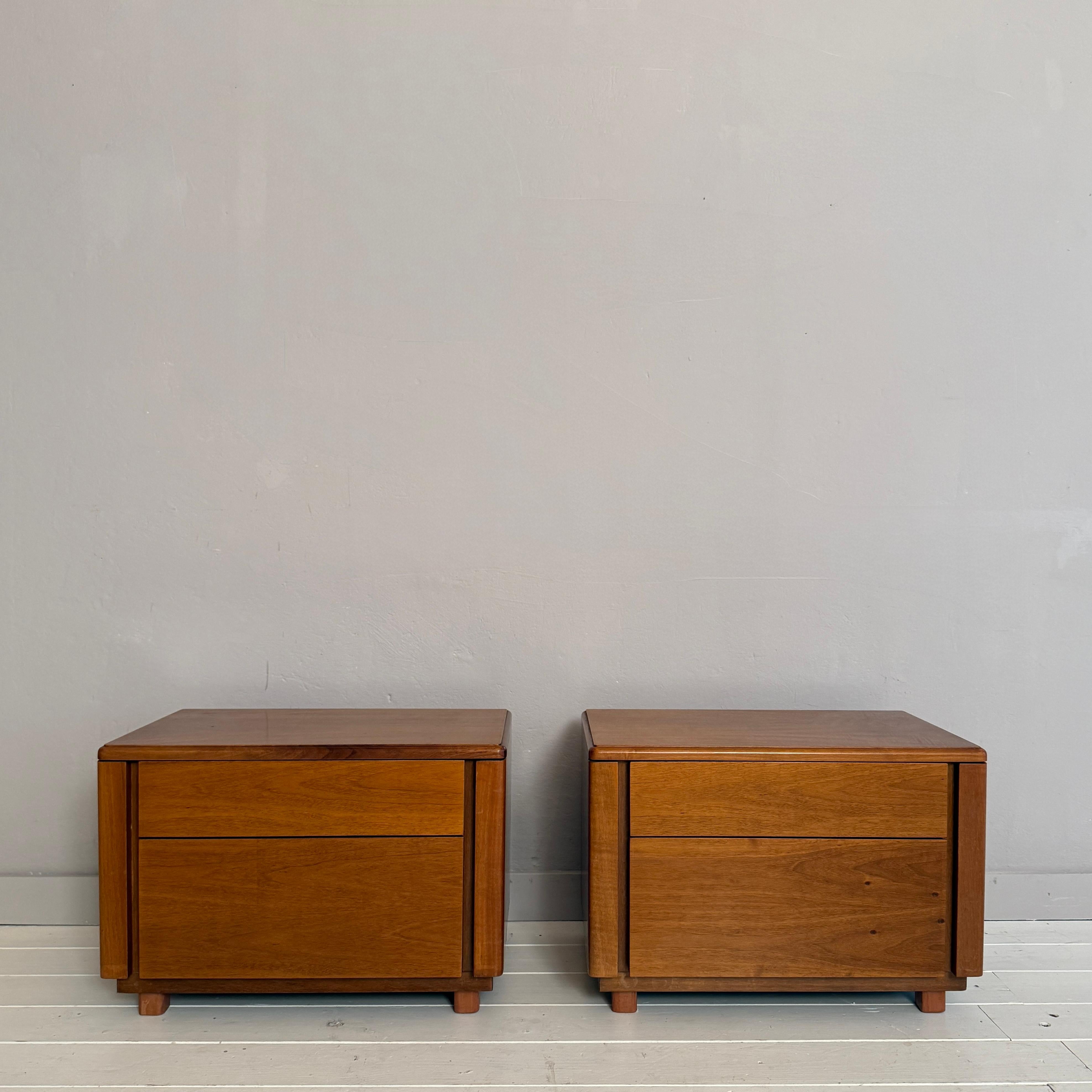 This elegant pair of Mid-Century bedside tables, crafted in walnut in Italy during the 1960s, showcases the refined simplicity and warm materiality characteristic of the period. Each table features two smoothly operating drawers, offering practical