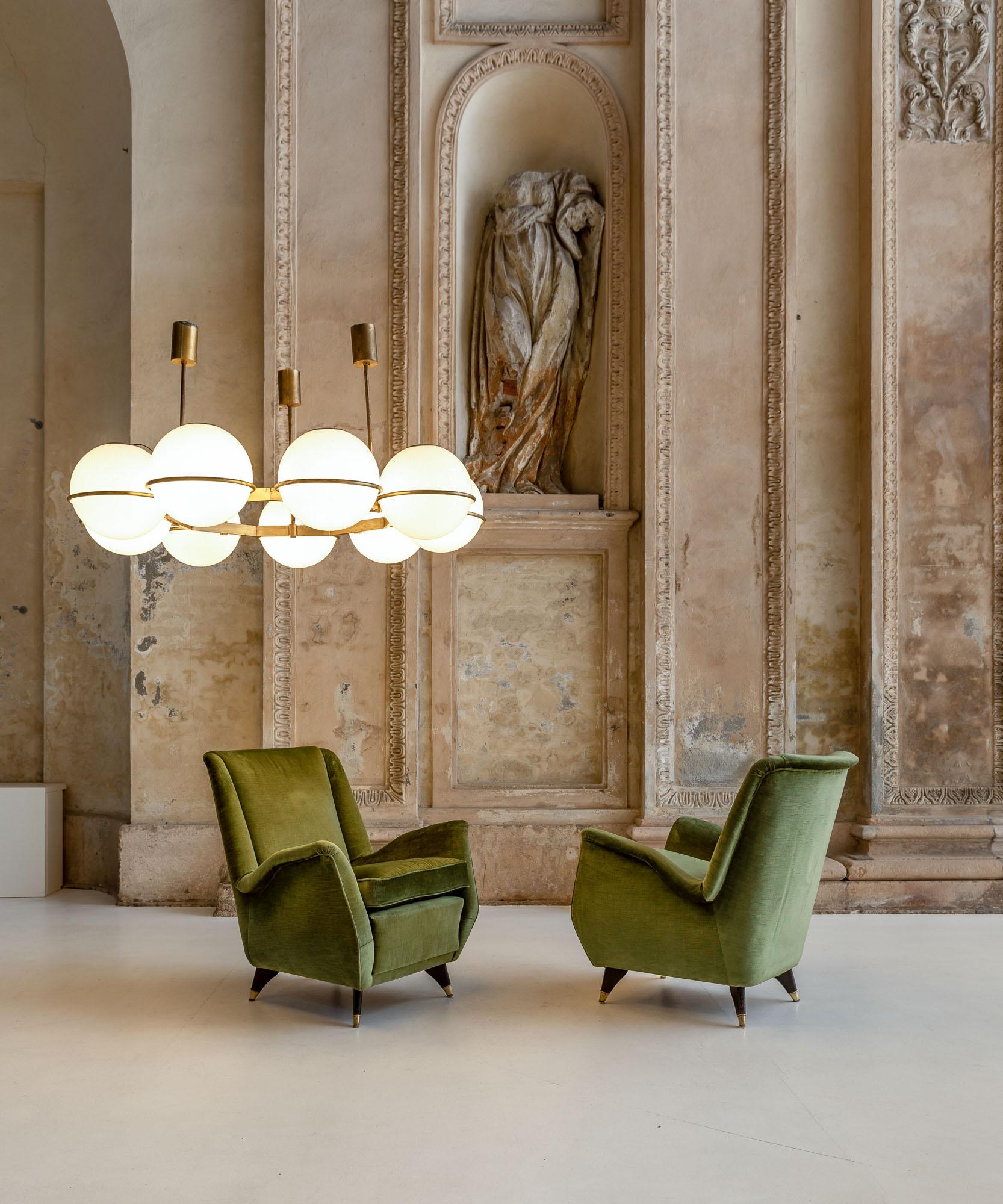 Iconic pair of green velvet armchairs by Isa.
Tapered wood and brass feet and very elegant shape and comfortable seats.
Original velvet upholstering.