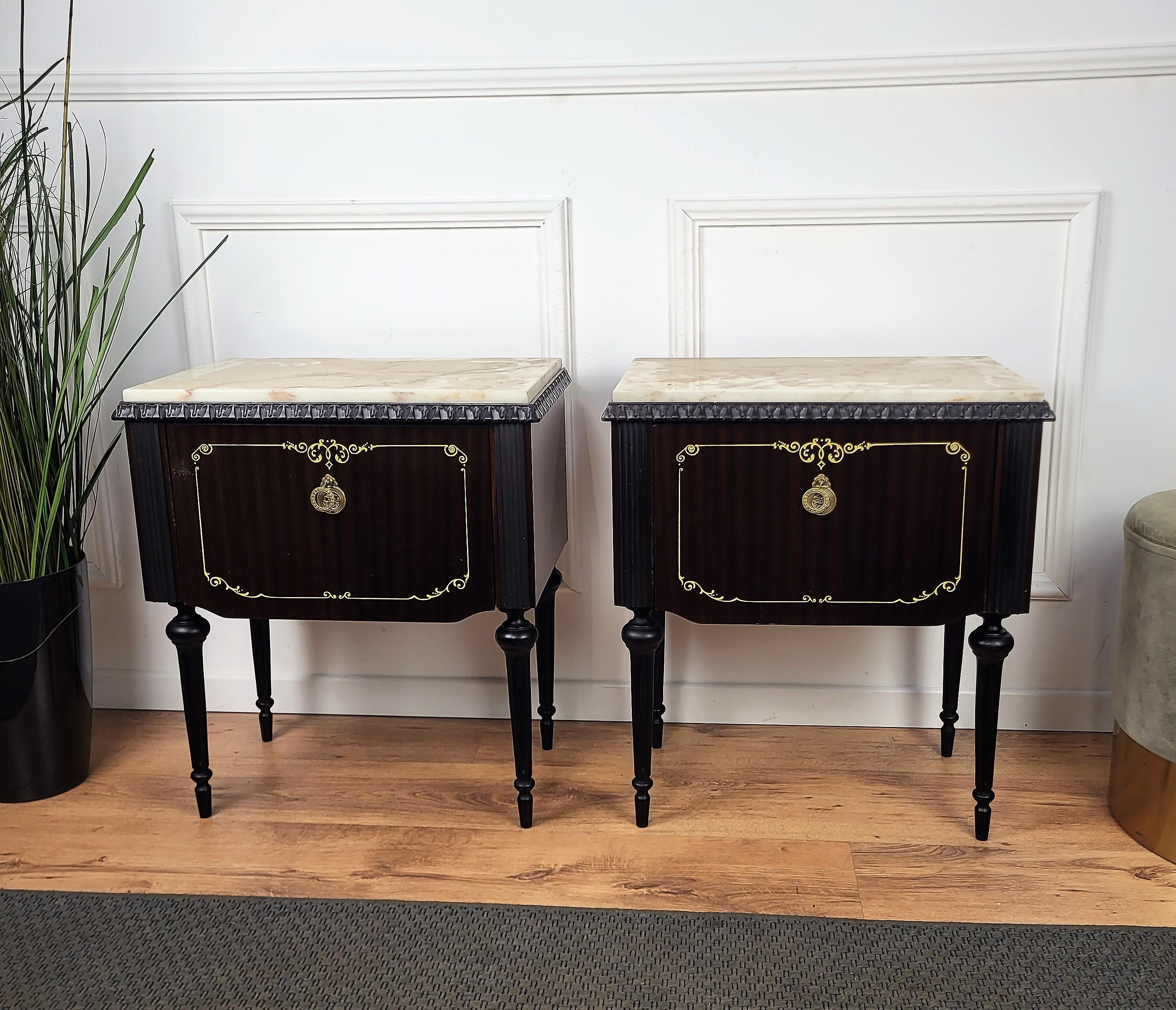 Very elegant and refined Italian 1950s neoclassical pair of bedside tables with flip opening and front gilt inlay decor and great pattern of the wood. Great details such as the brass handles and carved legs and marble top make those nightstands a