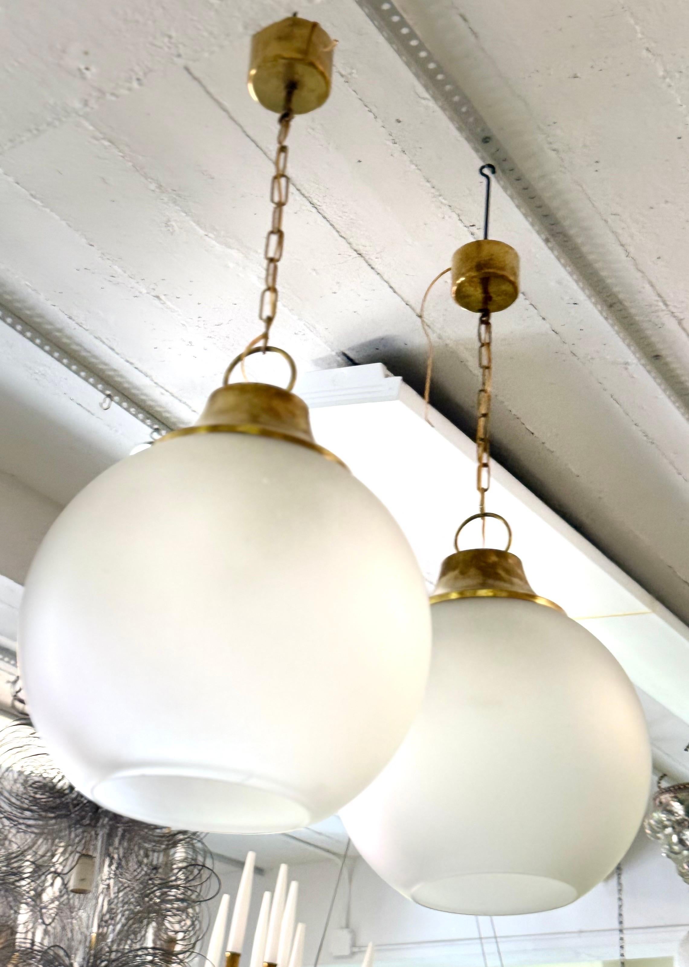 Hand-Crafted Pair of Italian Midcentury Brass & Satin Glass Ball Pendants by Caccia Dominioni For Sale