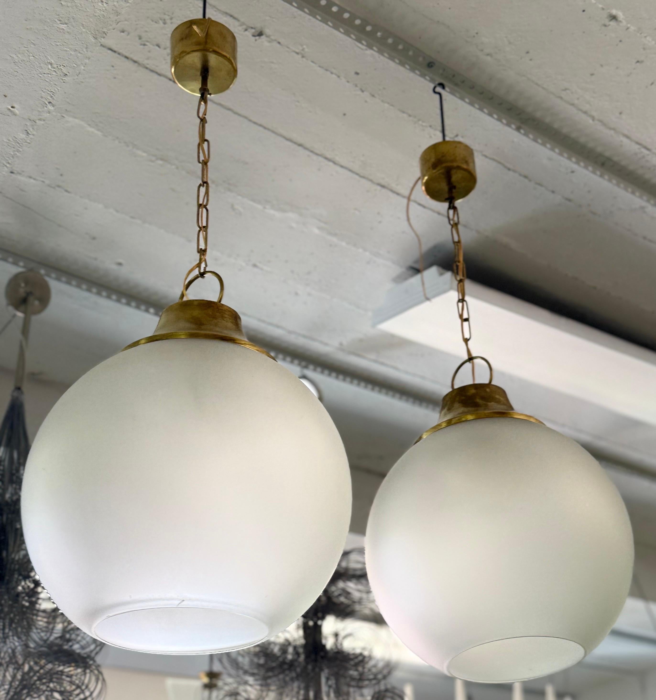 20th Century Pair of Italian Midcentury Brass & Satin Glass Ball Pendants by Caccia Dominioni For Sale