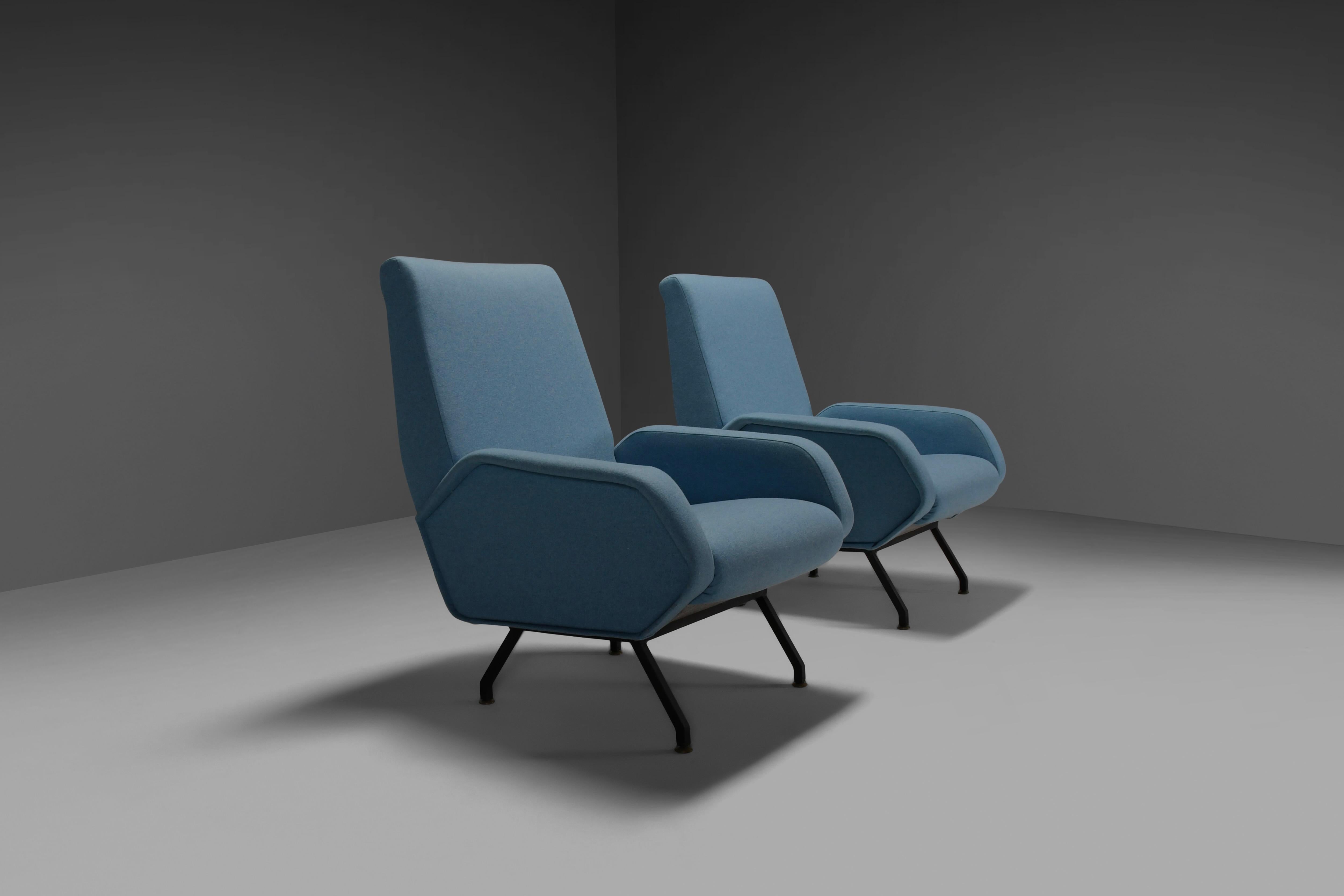 Pair of elegant midcentury Italian lounge chairs in excellent condition.

The chairs are redone in a fresh light blue wool and provided with new foam. 

The metal frame is lacquered black and has brass feet. 

From now on all large and fragile