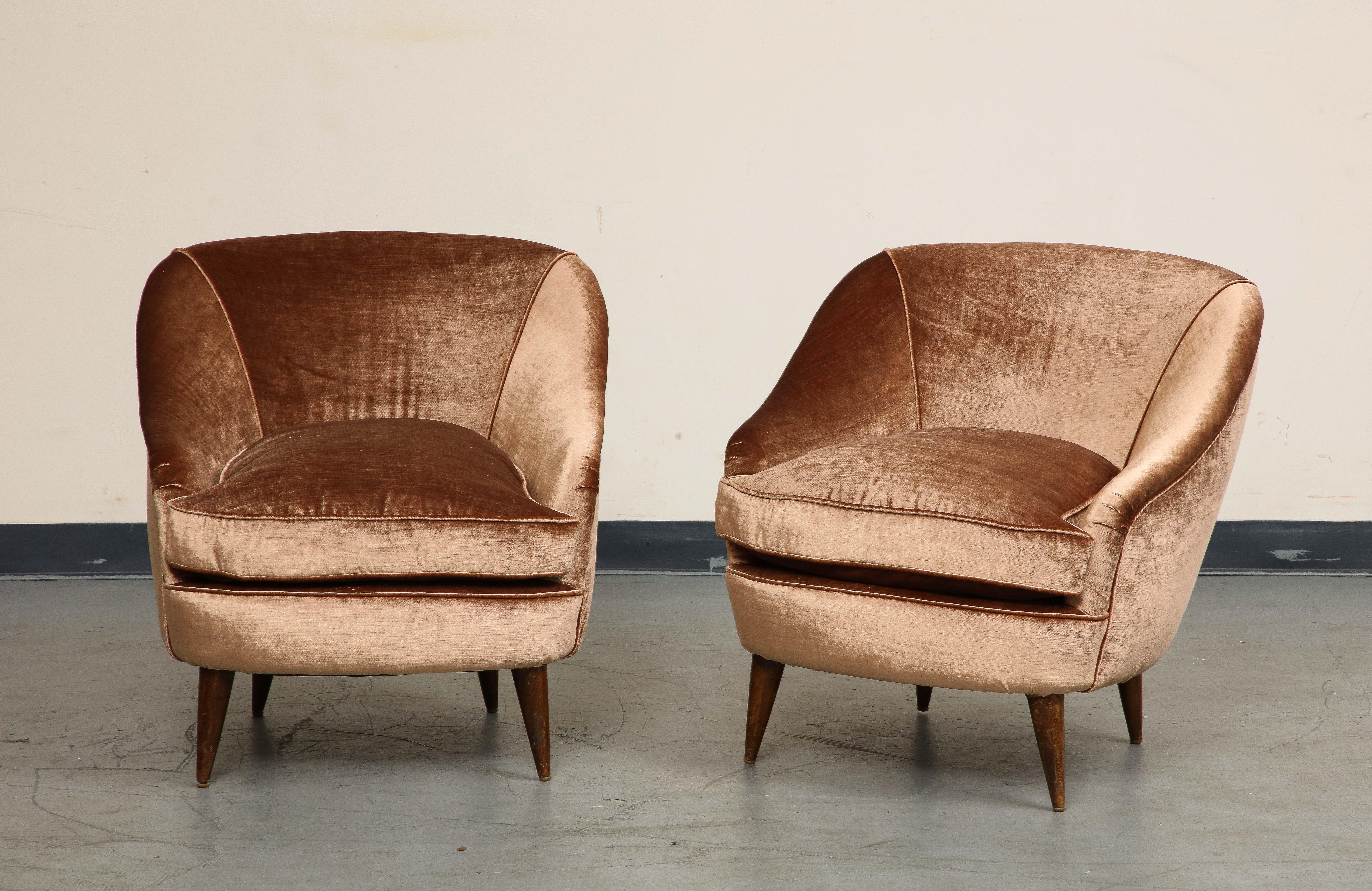 A pair of Mid-Century Modern Italian accent lounge chairs, newly upholstered in copper velvet. Oak tapered legs.