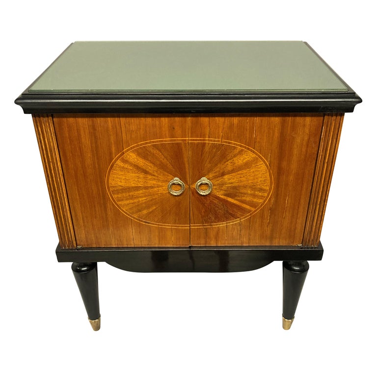 A pair of fine Italian mid-century night stands, finely veneered with ebonised detailing, brass sabot and champagne coloured glass tops.