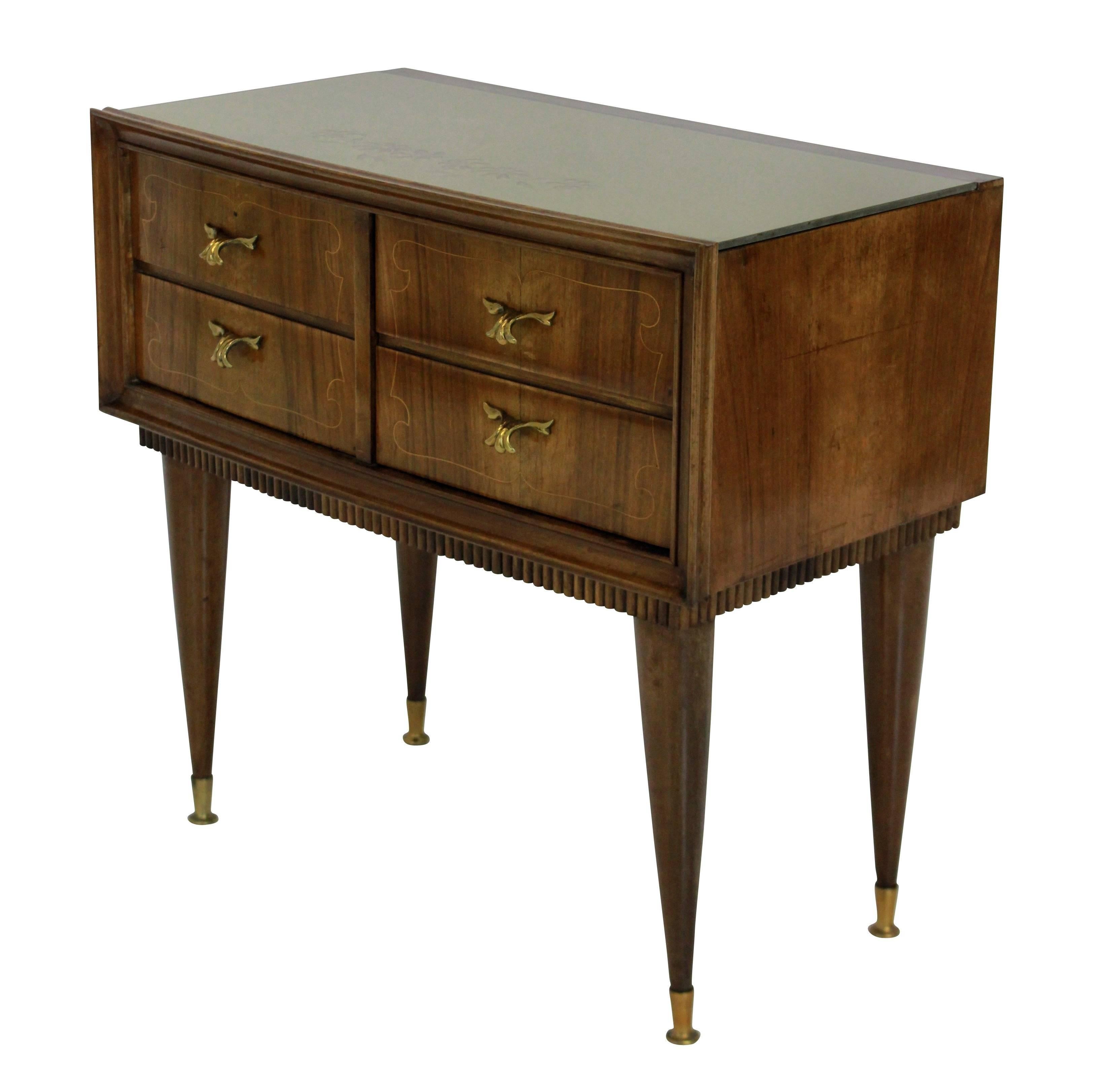 A pair of Italian midcentury nightstands in walnut, with figuring. Each having two drawers and a cupboard, with the original glass tops and brass fittings.
 