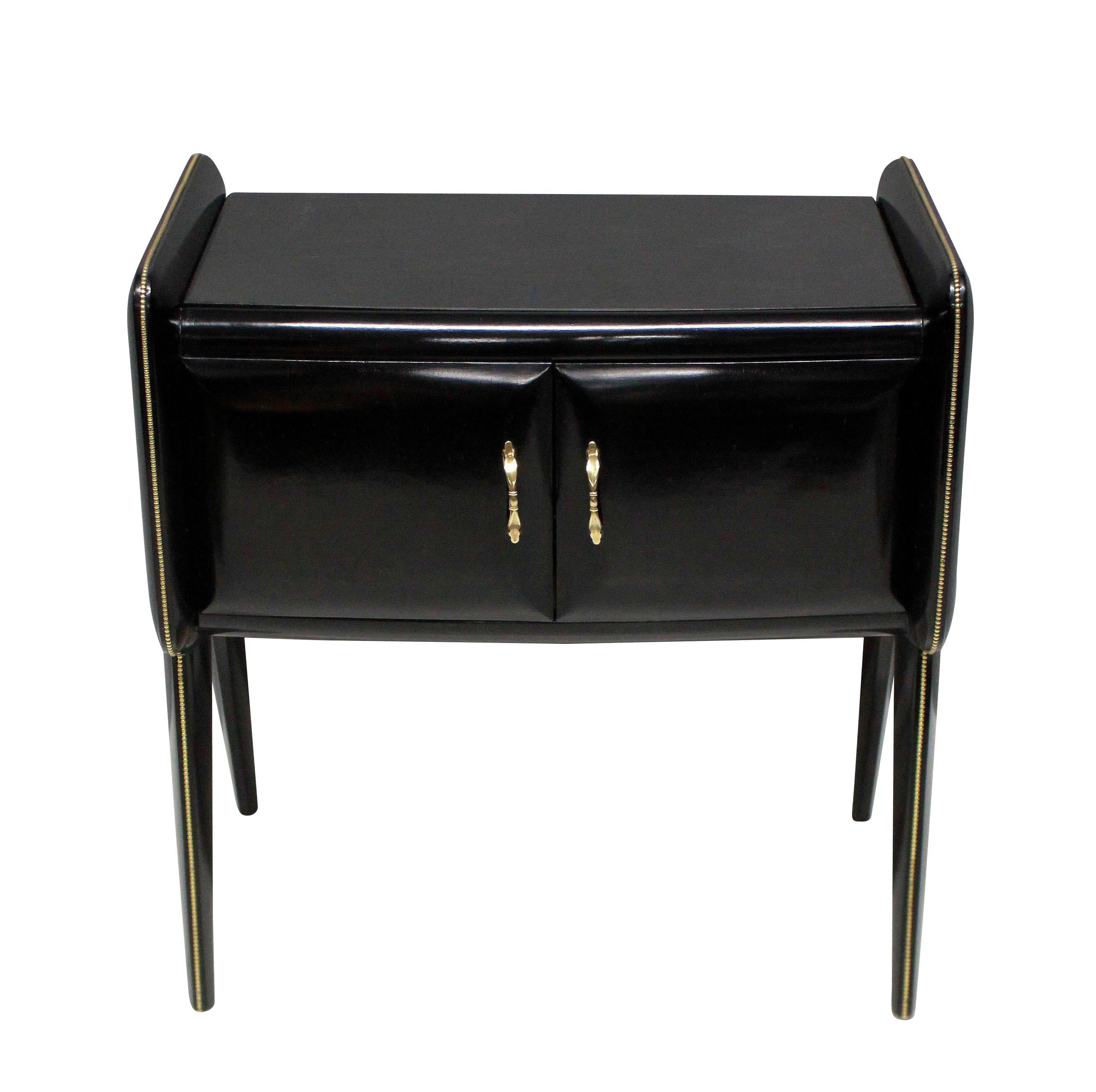 A pair of Italian midcentury ebonized nightstands with central cupboard, glass tops and attractive brass detailing.