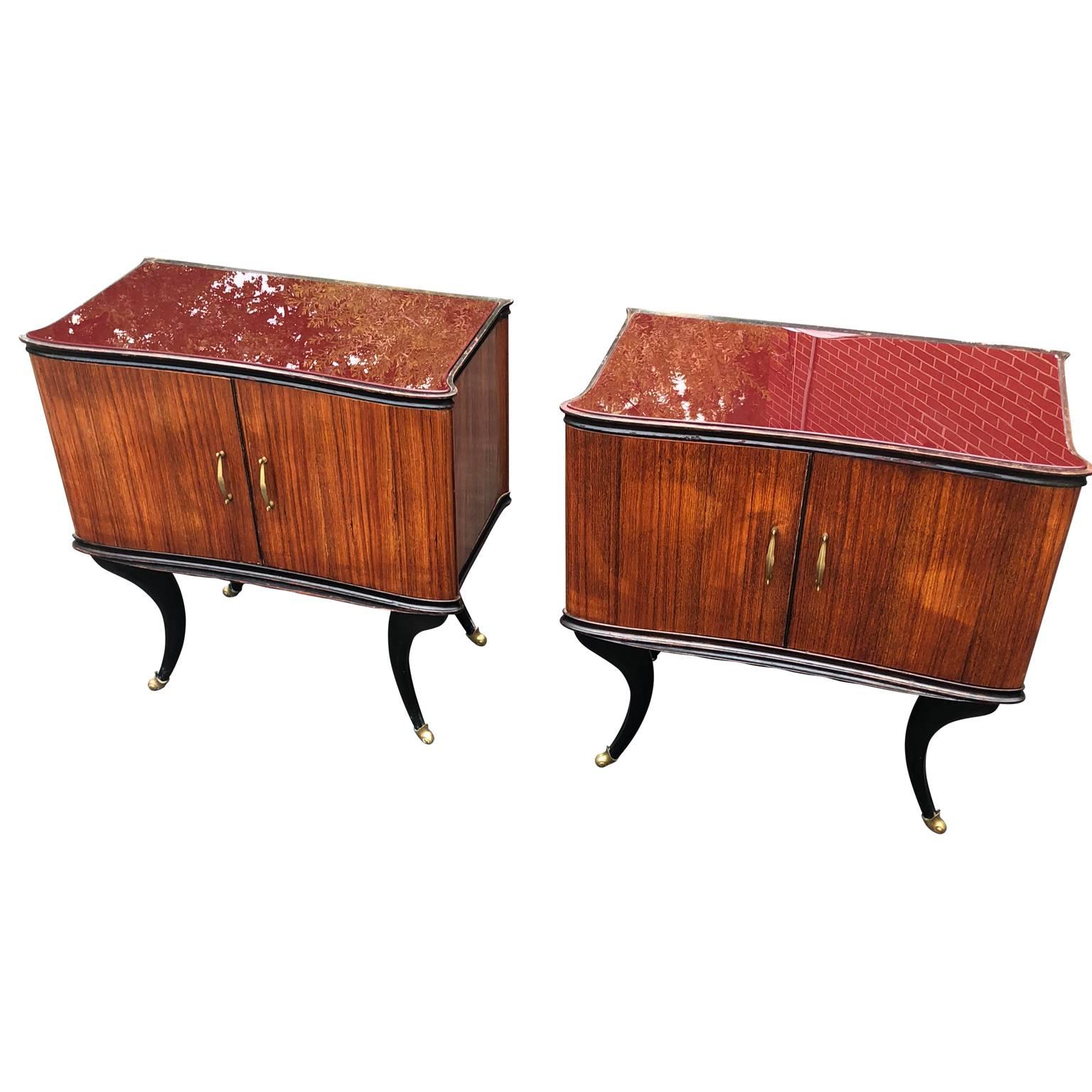 Pair of Italian Mid-Century Modern red glass-top bedside tables on brass-capped feet.
