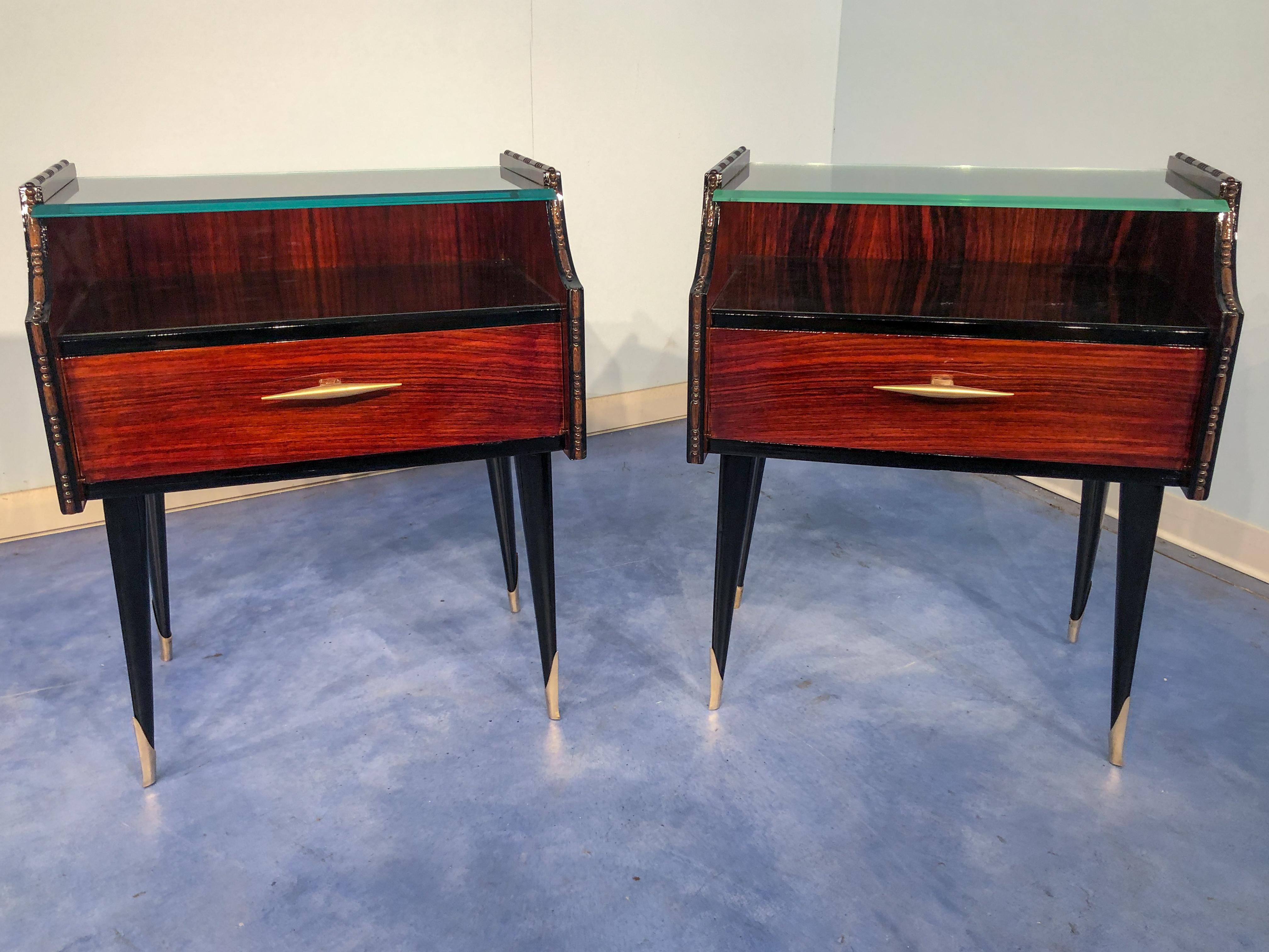 Elegant and stylish Italian midcentury teak nightstands or side tables 1960, with double glass, one transparent, slightly green, on the top, and black lacquered the second one. You can see the refined details such as the stylish brass handles or