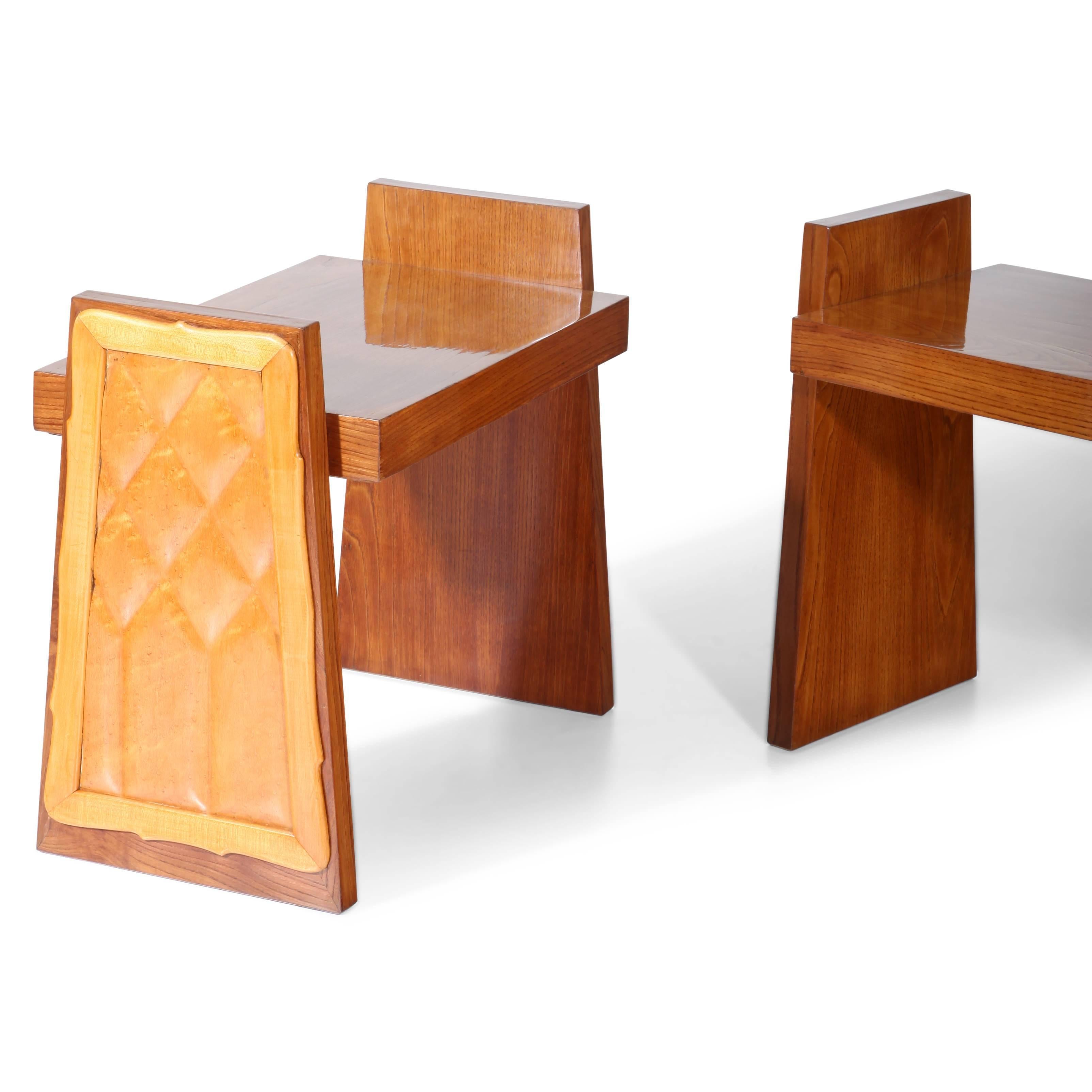 Pair of Italian midcentury stools or small benches, standing on trapezoidal legs with a framed and stepped décor panel.