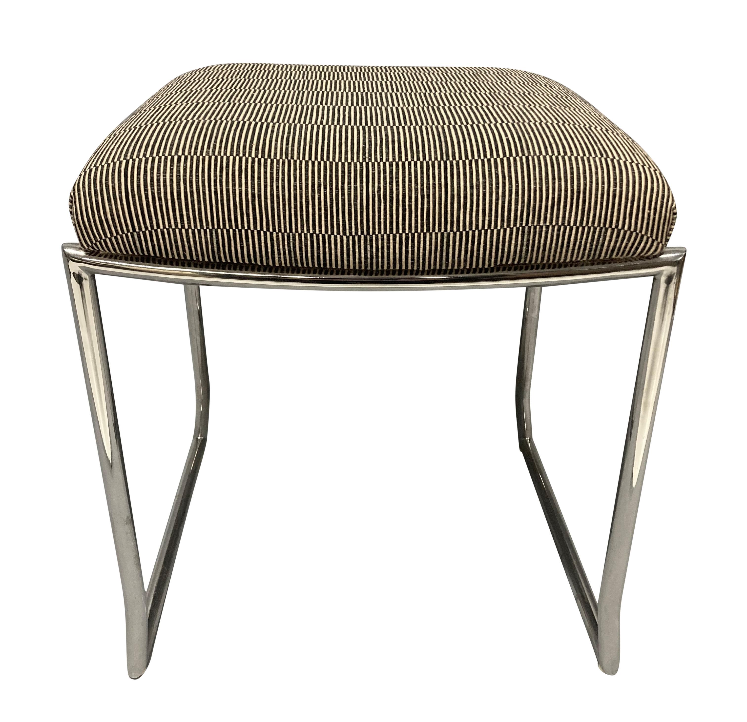 A pair of Mid-Century Italian stools in chrome, newly upholstered in a ribbed fabric. The stools are very heavy and sturdy, and have an interesting leg shape.