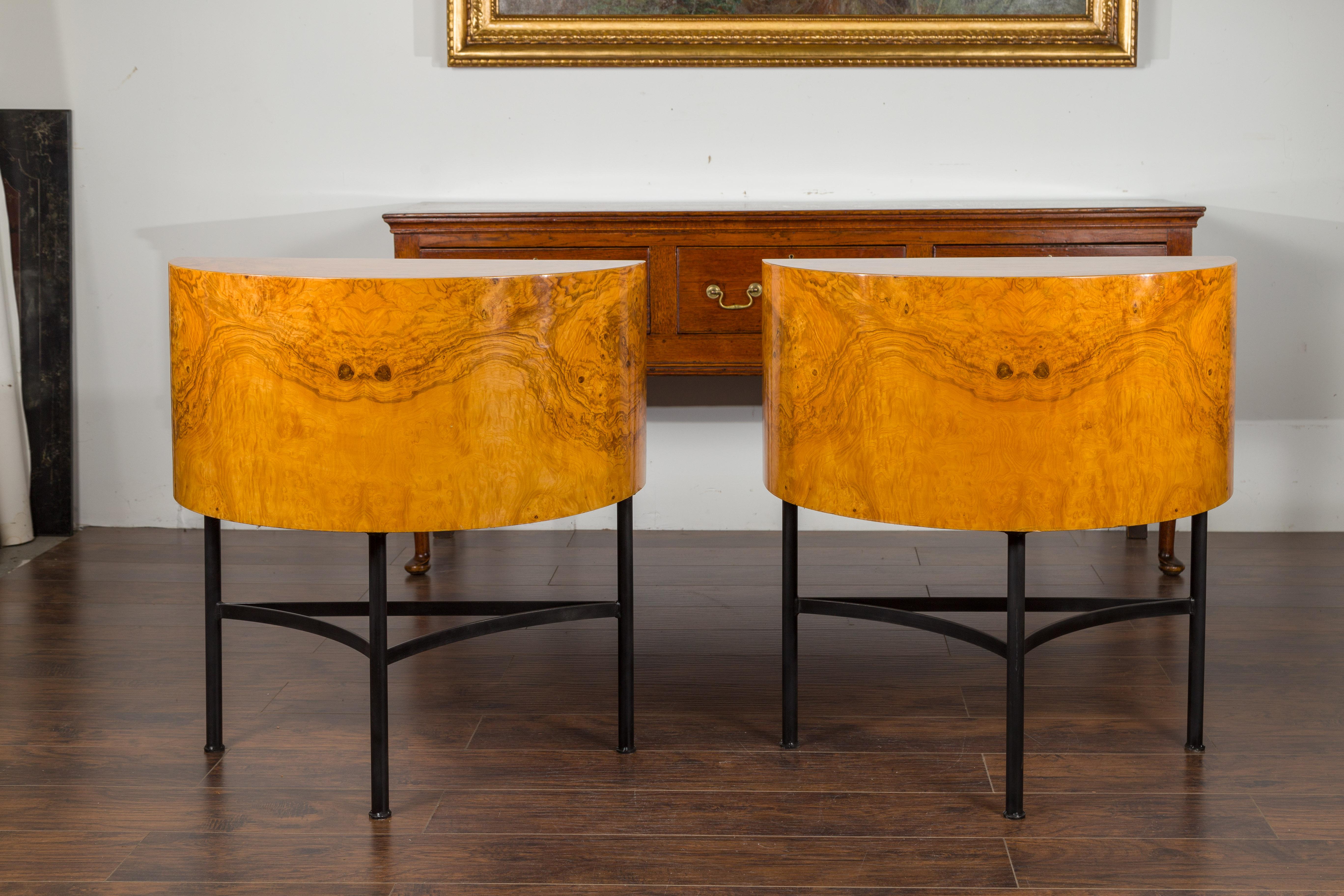 A pair of Italian vintage demilune tables from the mid-20th century, on custom iron bases. Created in Italy during the midcentury period, each of this pair of stylish demilunes features a semi-circular shape perfectly complimented by an exquisite
