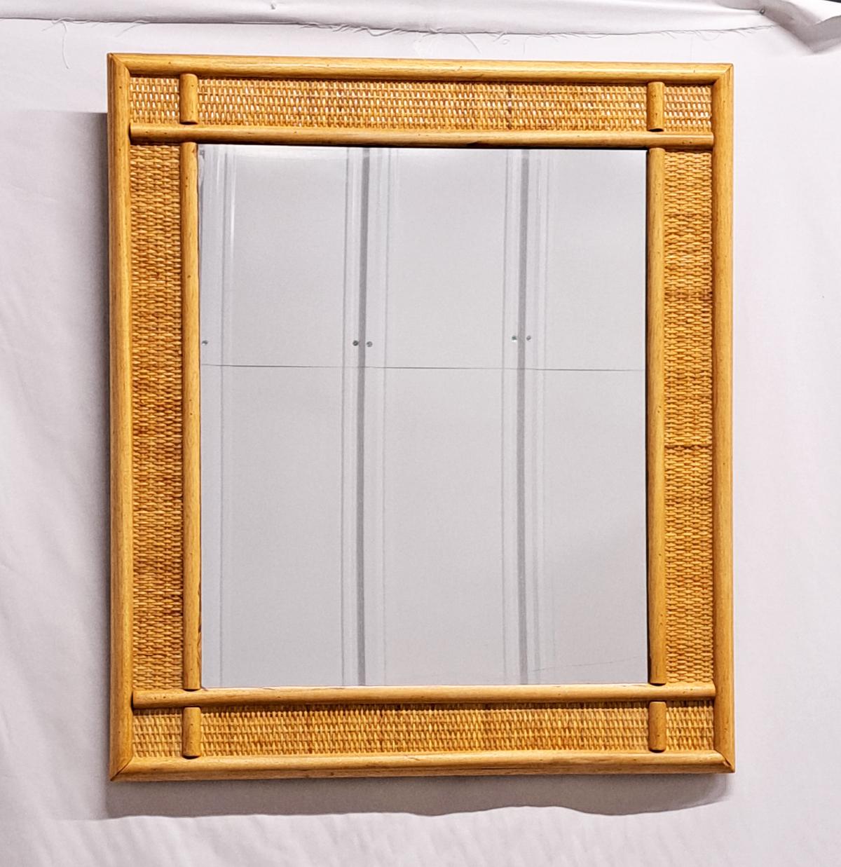 Midcentury rectangular mirror with bamboo frame and woven wicker. These items were produced in Italy in the 1970s. 
These mirrors are perfect for a midcentury touch or for decorating a midcentury and vibrant and fun living space. 
Dimensions: 70 W x