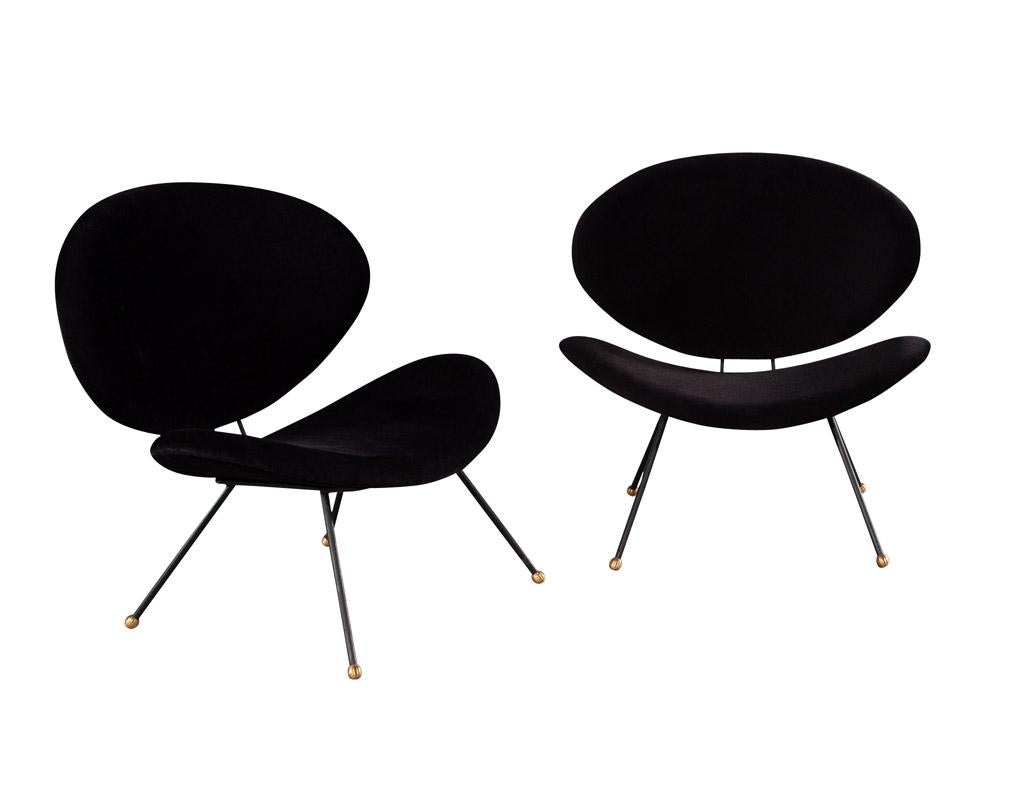 This pair of Italian modern black velvet accent chairs is the perfect addition to any home. With their rounded curved backs and seats, these chairs have a modern styling that will bring a touch of sophistication and comfort to any room. The black