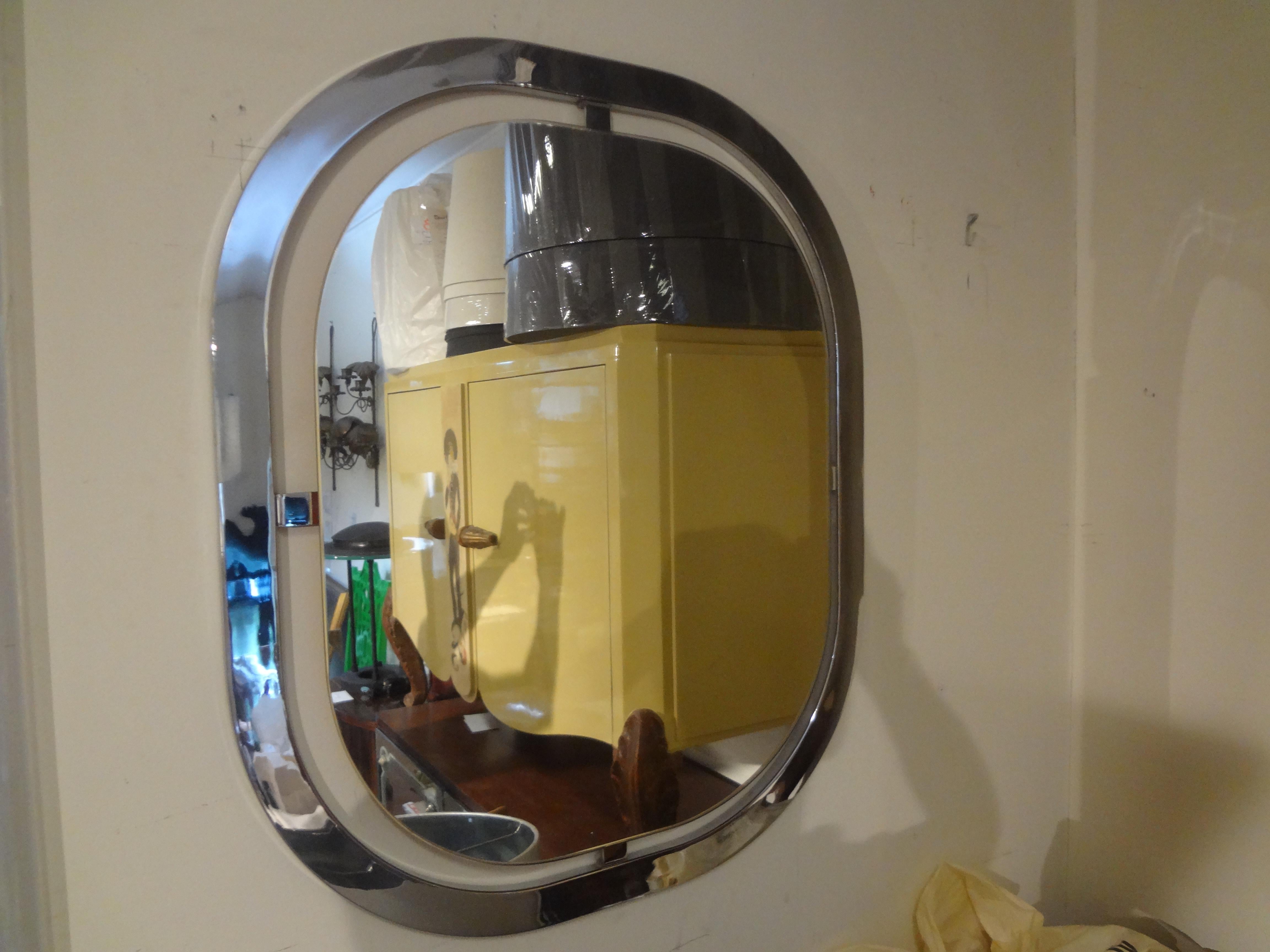 Pair of Italian Modern chrome mirrors. 
This stunning pair of Italian chrome mirrors have the appearance of floating
glass and are quite unique. In the manner of Romeo Rega.
Would display well above console tables, commodes, chests or buffets.