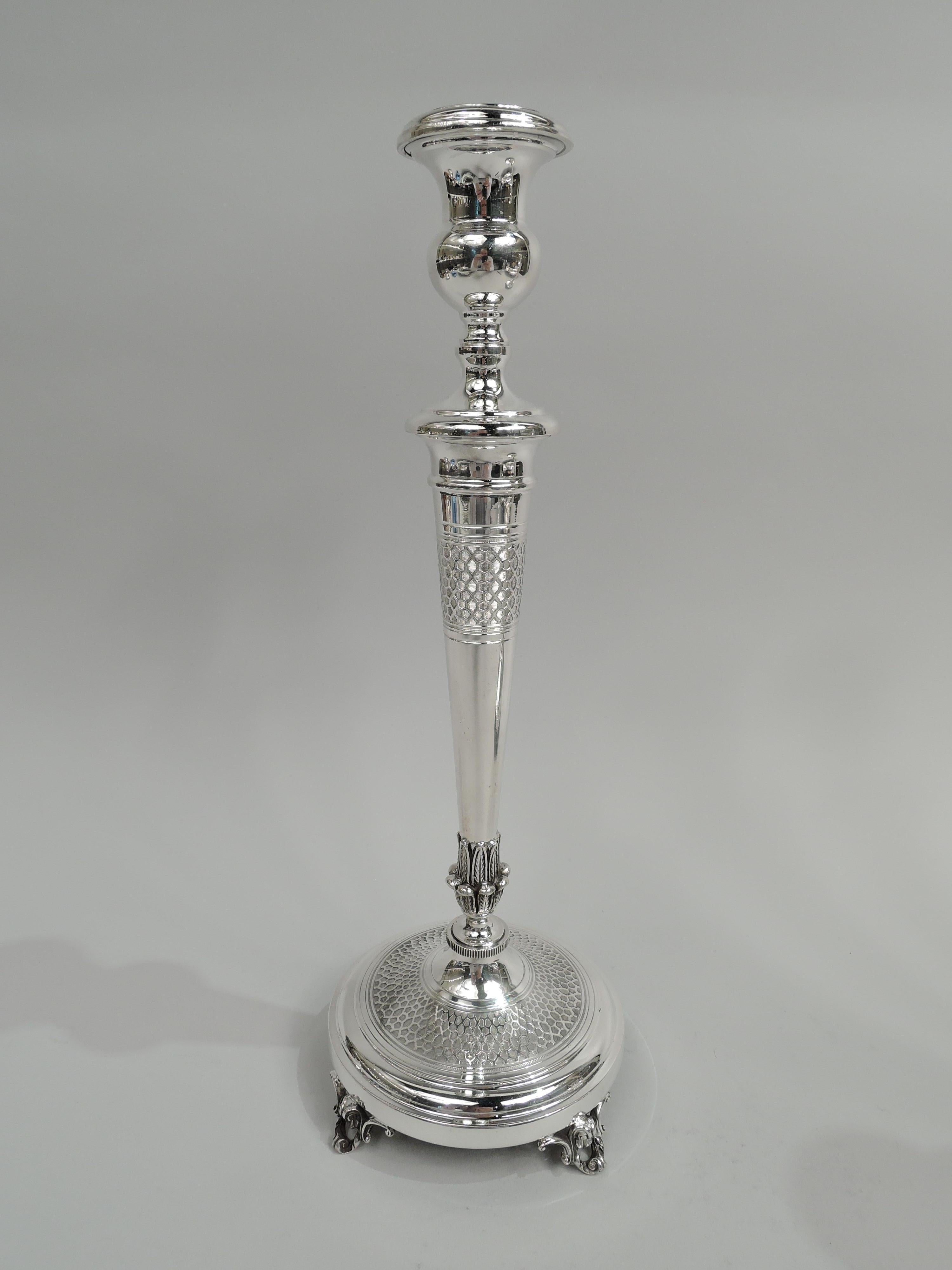Pair of Modern Classical sterling silver candlesticks. Each: Bellied urn socket on tapering columnar shaft with applied acanthus leaves at base; ribbed knop on raised foot supported by four open leafing scroll supports. Acid-etched honeycomb band on