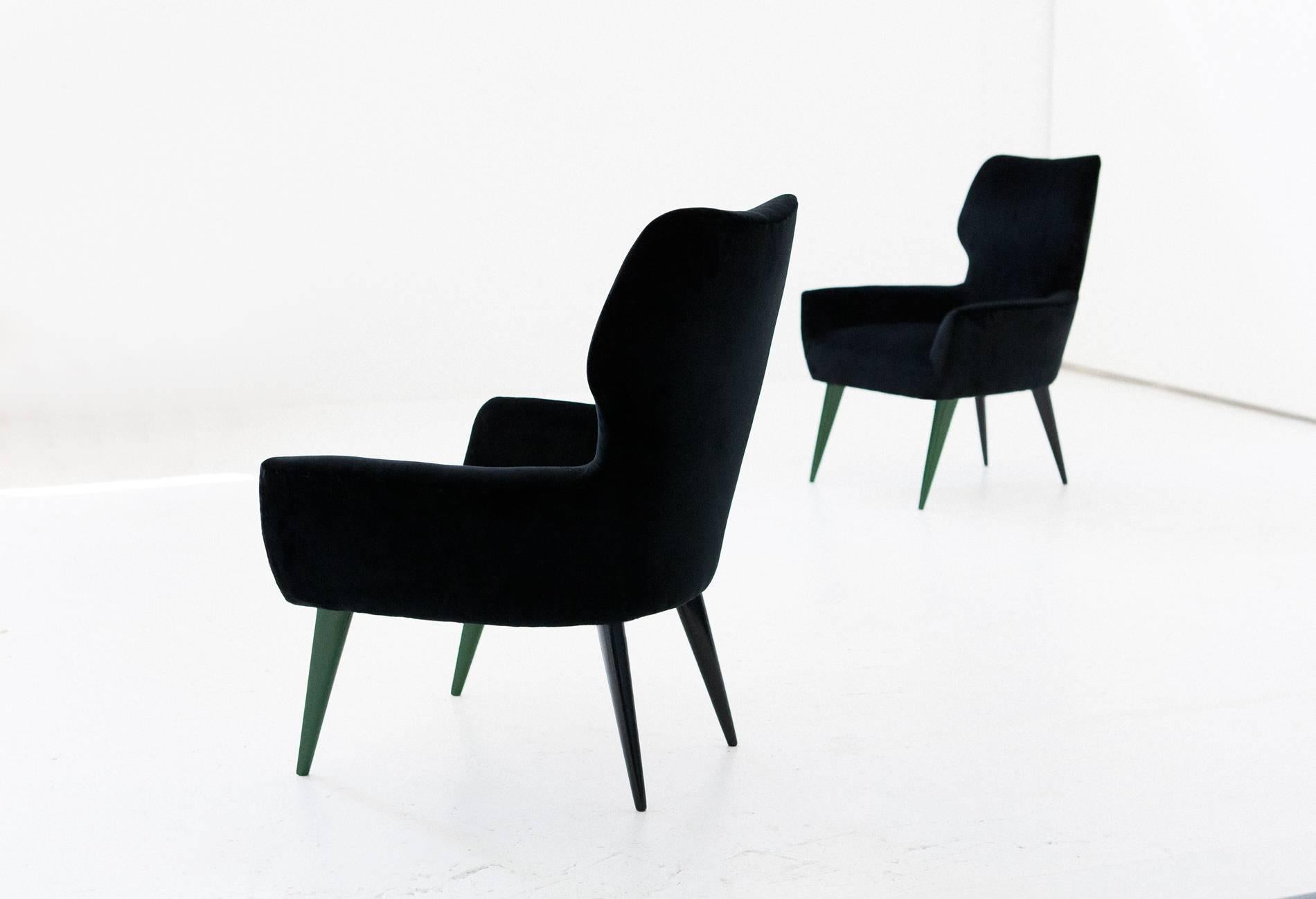 Pair of easy armchairs manufactured in Italy in the 1950s

New padding and new upholstery with black cotton velvet.
Mahogany black and green lacquered legs, you can request a different front legs color.

 