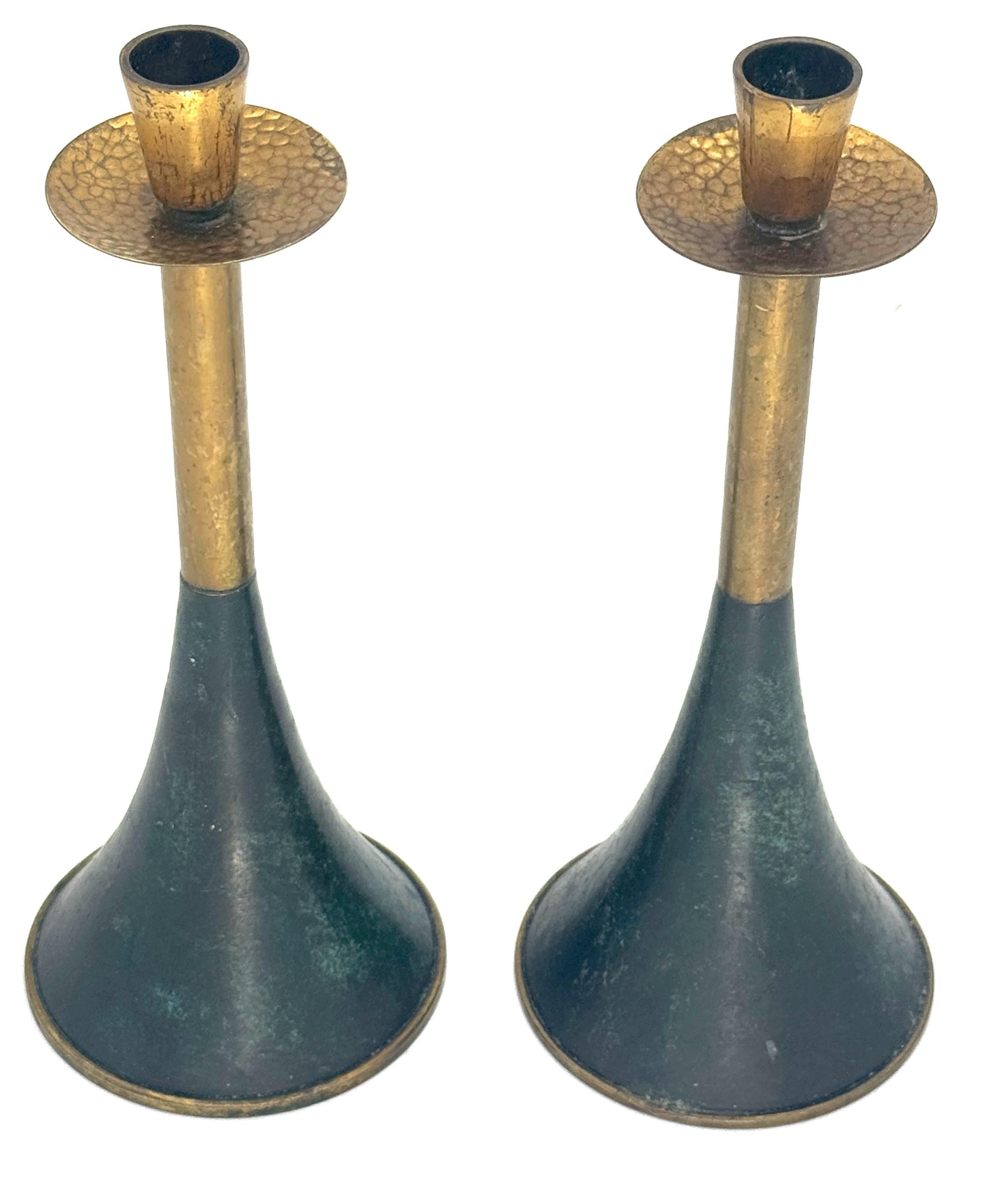 Pair of Italian Modern Gilt and Patinated Brass Conical Candlesticks

Italy, circa 1970s

A sculptural pair of Italian Modern candlesticks, each composed of a slender, trumpet-form silhouette with a flared conical base and gently tapered stem. The