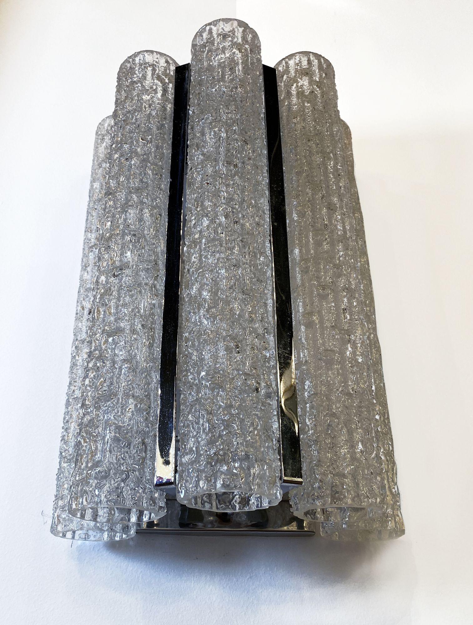 The handblown glass tubes between a chrome semi circular framework.