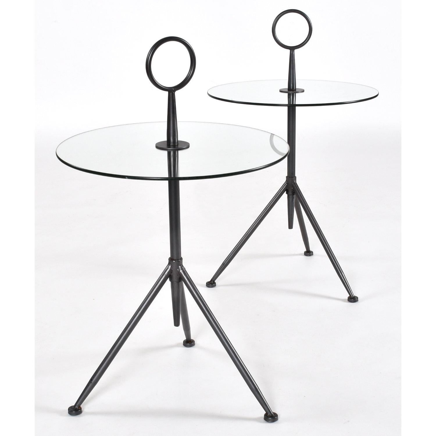 Elegant pair of round Italian modern gueridon side tables. The unique three-legged side tables have a striking sculptural design. These tables make the perfect drink tables. Use the top handle to easily re-arrange the lightweight Cocktail Tables.