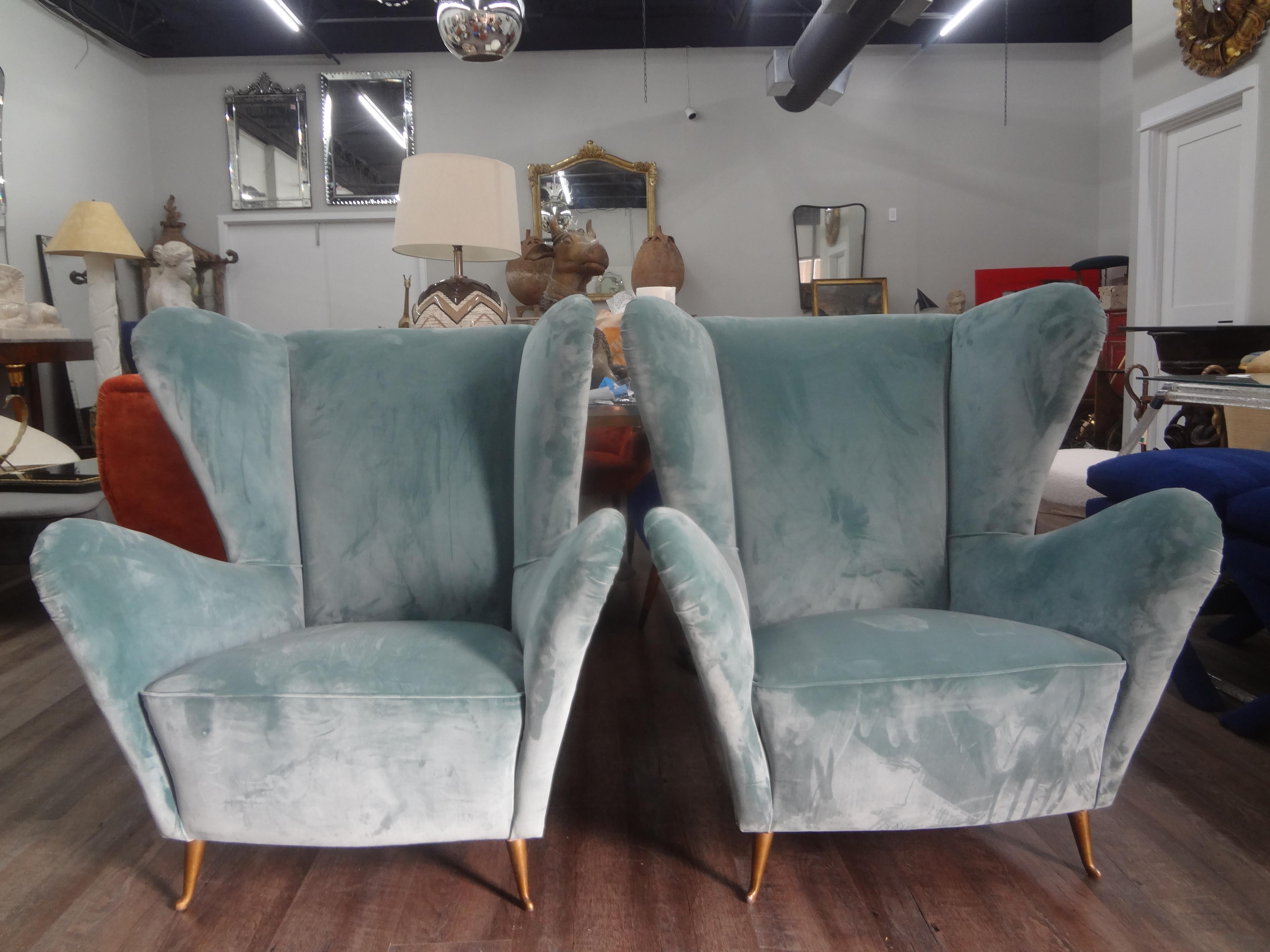 Pair of Italian Modern sculptural lounge chairs attributed to ISA Bergamo.
This stunning pair of Mid-Century Modern Italian lounge chairs, side chairs or wing chairs have a great sculptural back that is not only stylish but extremely comfortable.